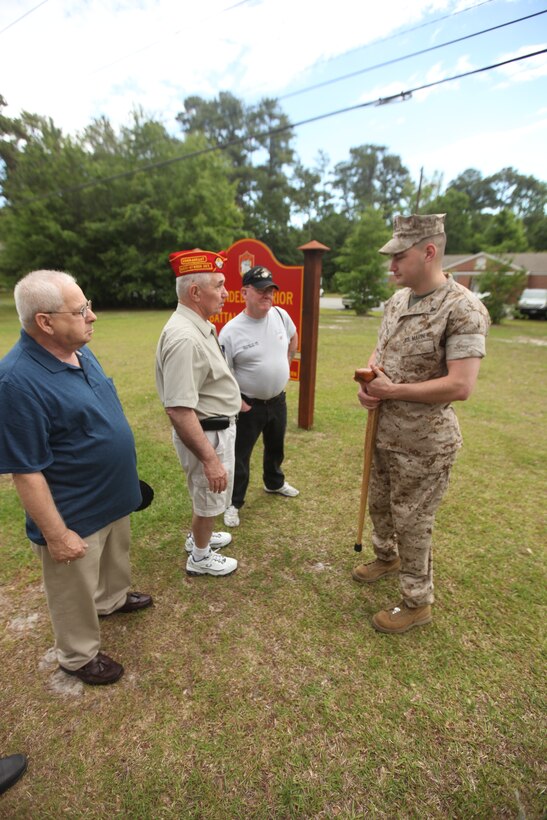 Joe Chasse (left) and Wayne Salisbury speak with Cpl. Matthew Bradford about his injuries and the quality of care he receives at the Wounded Warrior Battalion East headquarters aboard Marine Corps Base Camp Lejeune May 17. Chasse, Salisbury and four other members from the Marine Corps Leauge Bucci-Atwood Post 376 traveled from Providence, R.I., to make a donation to the battalion and to ensure the Marines are getting the best care possible.