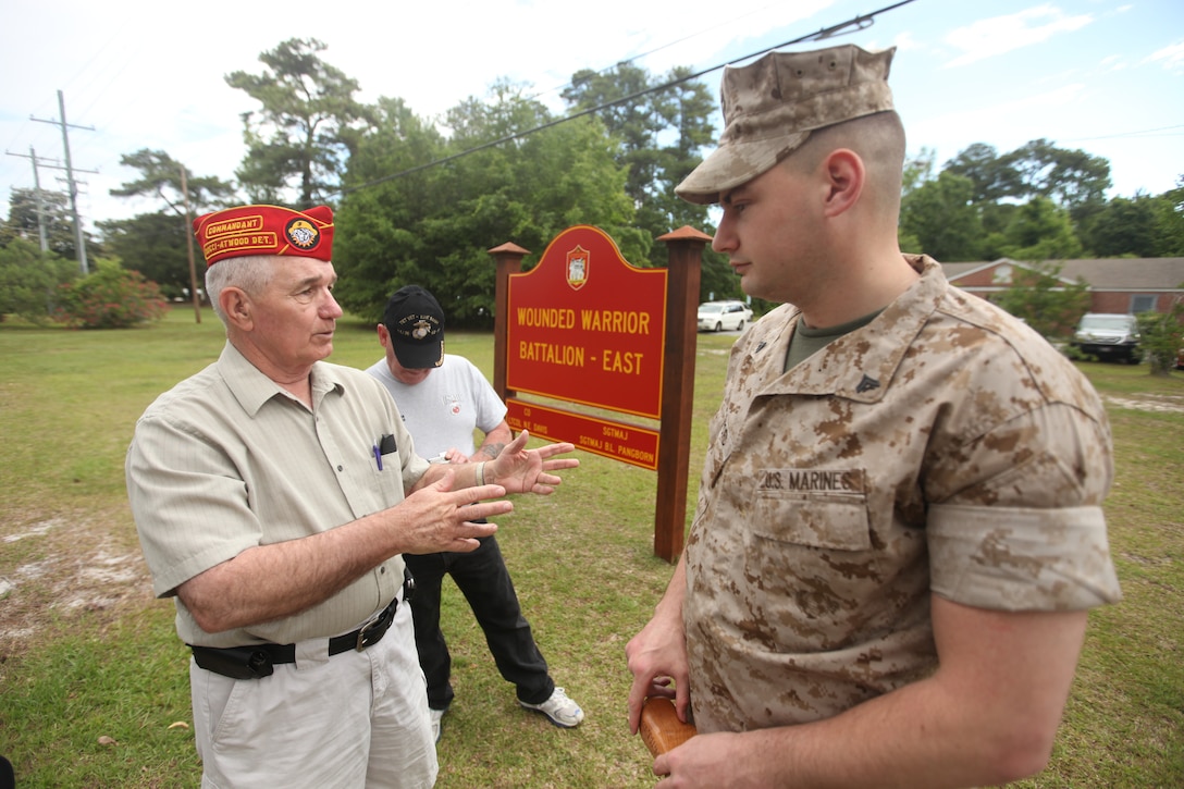 Joe Chasse speaks with Cpl. Matthew Bradford about his injuries and the quality of care he receives at the Wounded Warrior Battalion-East headquarters aboard Marine Corps Base Camp Lejeune, May 17. Chasse and five other members from the Marine Corps Leauge Bucci-Atwood Post 376 traveled from Providence, R.I., to make a donation to the battalion and to ensure the Marines are getting the best care possible.