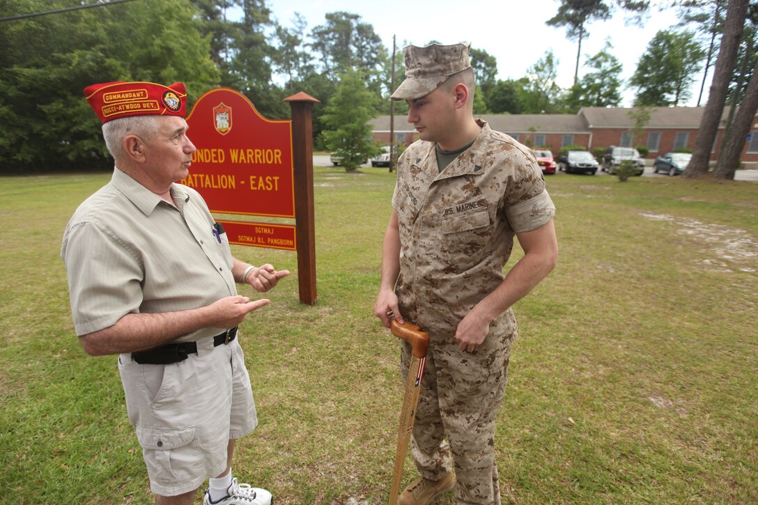 Joe Chasse speaks with Cpl. Matthew Bradford about his injuries and the quality of care he receives at the Wounded Warrior Battalion-East headquarters aboard Marine Corps Base Camp Lejeune, May 17. Chasse and five other members from the Marine Corps Leauge Bucci-Atwood Post 376 traveled from Providence, R.I., to make a donation to the battalion and to ensure the Marines are getting the best care possible.