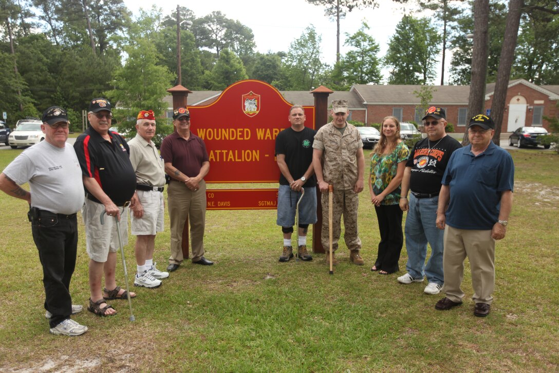 Marine Corps League Bucci-Atwood Post 376 members and wounded warriors take a second to pose in front of the Wounded Warrior Battalion East headquarters aboard Marine Corps Base Camp Lejeune May 17. The members, from Providence, R.I., made the trek to MCB Camp Lejeune to show their appreciation for the wounded warriors.