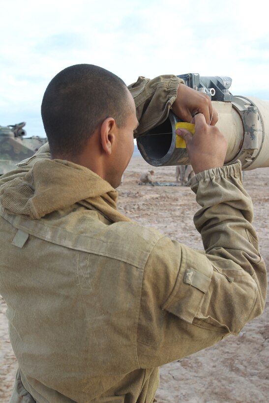 Corporal William Haynes, a tank mechanic sets up strings to bore sight the main cannon on the commanding officer’s M1 Abrams in preparation of the final exercise of operation Urban Thunder in the Lead Mountain training area May 17, 2011.