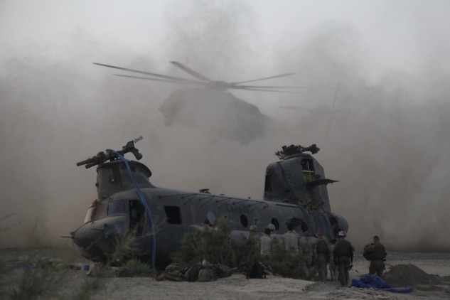 A Marine Heavy Helicopter Squadron 461 CH-53E Super Stallion lands next to a downed Canadian Forces CH-47 Chinook during a tactical recovery of aircraft and personnel mission in Kandahar Province, Afghanistan, May 17. Utilizing a trio CH-53E Super Stallion helicopters from Marine Heavy Helicopter Squadron 461, with assistance from 2nd Marine Logistics Group’s helicopter support team, the Canadian and American team was able to transport the injured aircraft back to its home at Kandahar Airfield, Afghanistan.