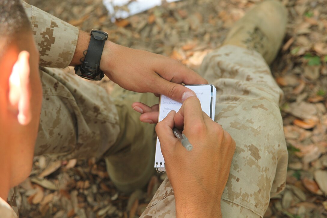 A 2nd Low Altitude Air Defense Battalion Marine takes notes during a mission brief before their foot patrol of the dense vegetation surrounding Marine Corps Auxiliary Landing Field Bogue May 17-19. Marines of Battery B went to Bogue to conduct foot patrols, stationary air defense and convoy air defense training.