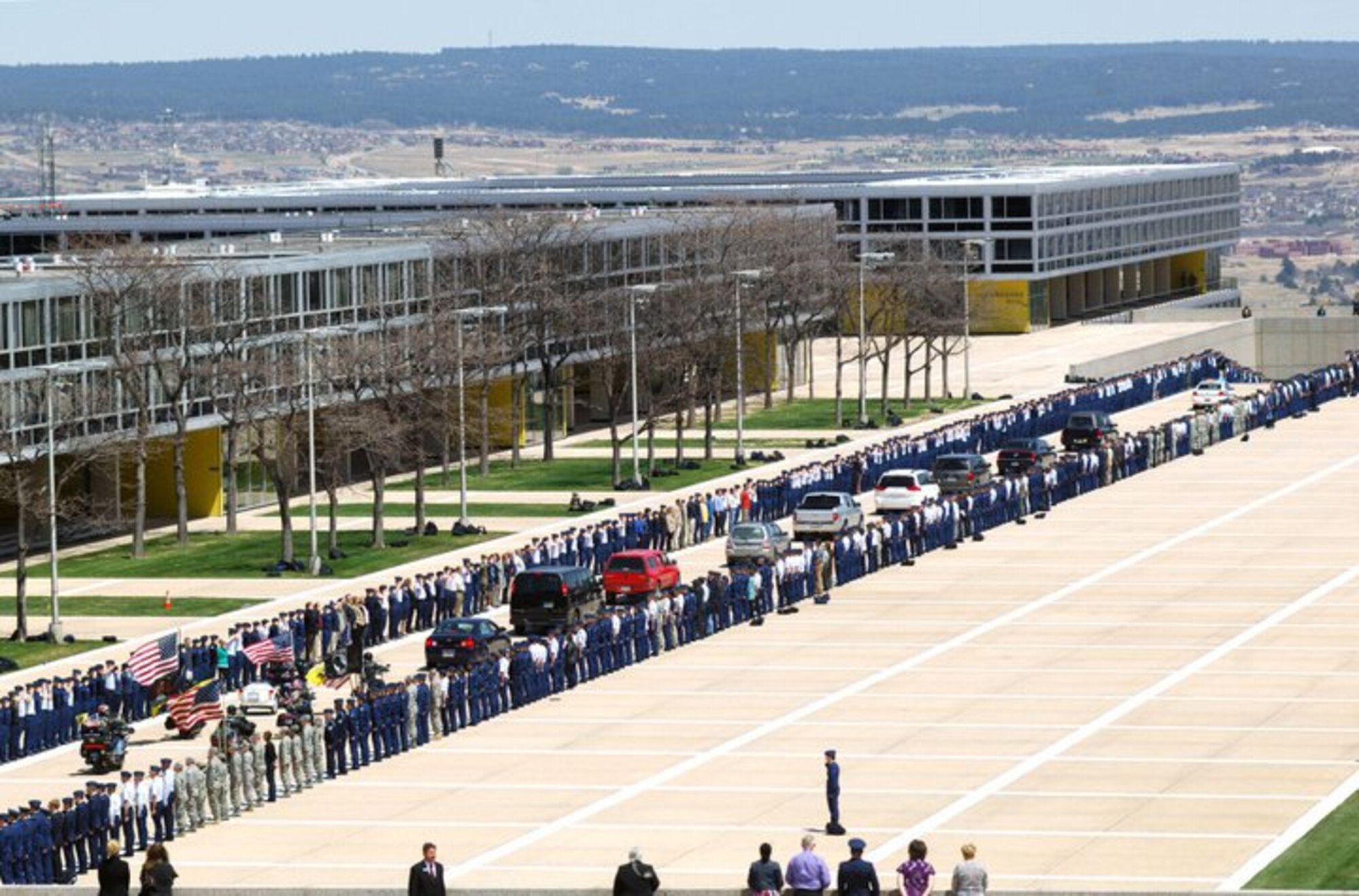 Students and staff memebers at the U.S. Air Force Academy in Colorado Springs line the street as the funeral procession for Maj. Philip Ambard, an academy foreign language professor, passes by. Maj. Ambard, a father of five, lost his life while deployed in Kabul, Afghanistan. (U.S. Air Force Courtesy Photo)