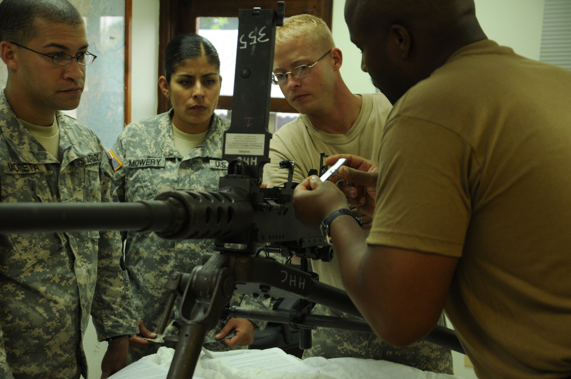 SOTO CANO AIR BASE, Honduras - Joint Task Force-Bravo had nine members attend and successfully complete the Unit Armors Certification Course May 9-13. Here Specialist Angelia Mowery observes as instructor, Sergeant 1st Class Jack Graves explains head space and timing on a .50 cal machine gun. (U.S. Air Froce photo/Staff Sgt. Kimberly Rae Moore)
