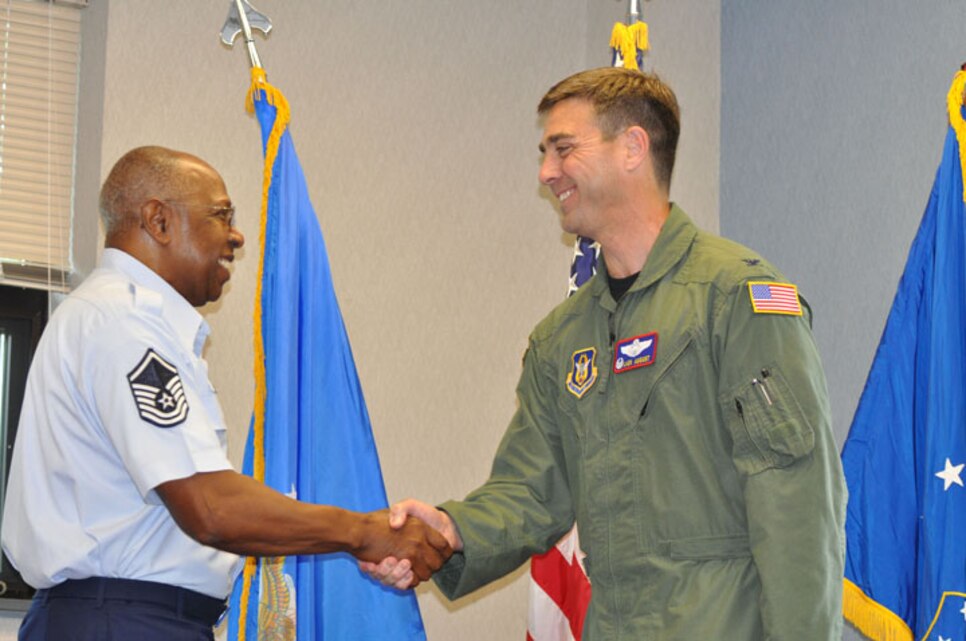 Col. Laen August, 916th Air Refueling Wing vice commander (right), congratulates Master Sgt. James Coley, 916th Command Post, on his re-enlistment in the Air Force Reserve. Wing leadership welcomes and congratulates other members of the wing in the month of May. (USAF photo by Ms. Donna Lea, 916ARW/PA)