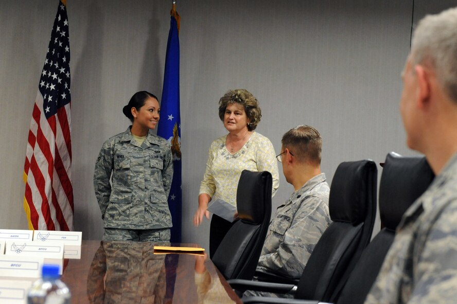 Retired Chief Master Sgt. Cathy Smith, Shreveport/Bossier City Military Affairs Council, congratulates Airman 1st Class Karina Reyes, 2nd Contracting Squadron, for achieving 2nd Bomb Wing Airman of the month, Barksdale Air Force Base, La., May 17. Airman Reyes was congratulated by Air Force Global Strike Command commander Lt. Gen. James Kowalski and 2nd Bomb Wing commander Col. Tim Fay and several members of the local community. (U.S. Air Force photo/Airman 1st Class Micaiah Anthony)(RELEASED) 