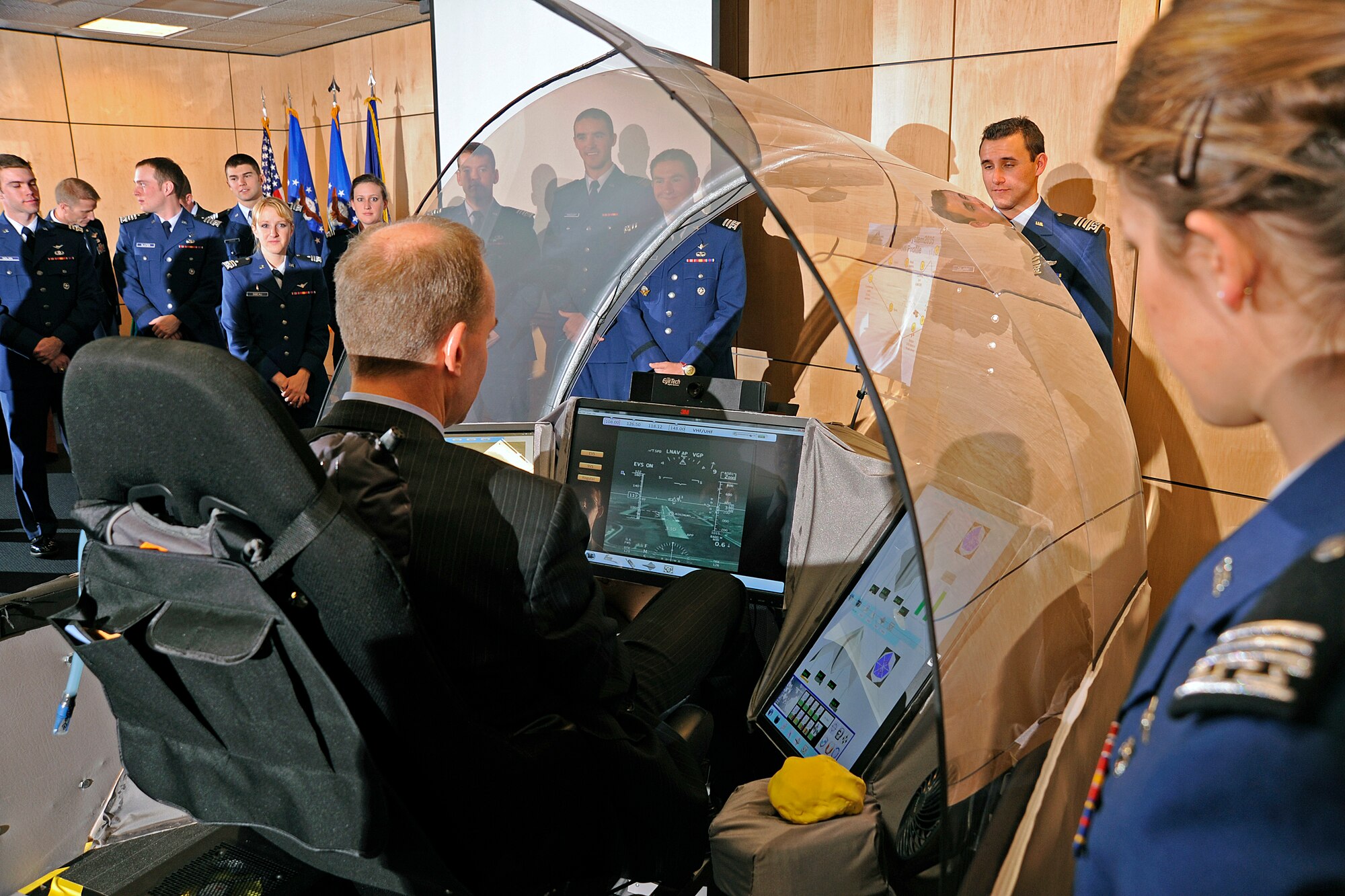 Dennis Muilenburg, president and CEO of Boeing Defense, Space, and Security, checks out the cockpit of the future designed by the Air Force Academy cadets in the background. The Academy's cockpit won the Boeing CrewSystem 2035 design challenge, beating out teams from the U.S. Naval Academy and and the U.S. Military Academy. (U.S. Air Force Photo/Raymond McCoy)