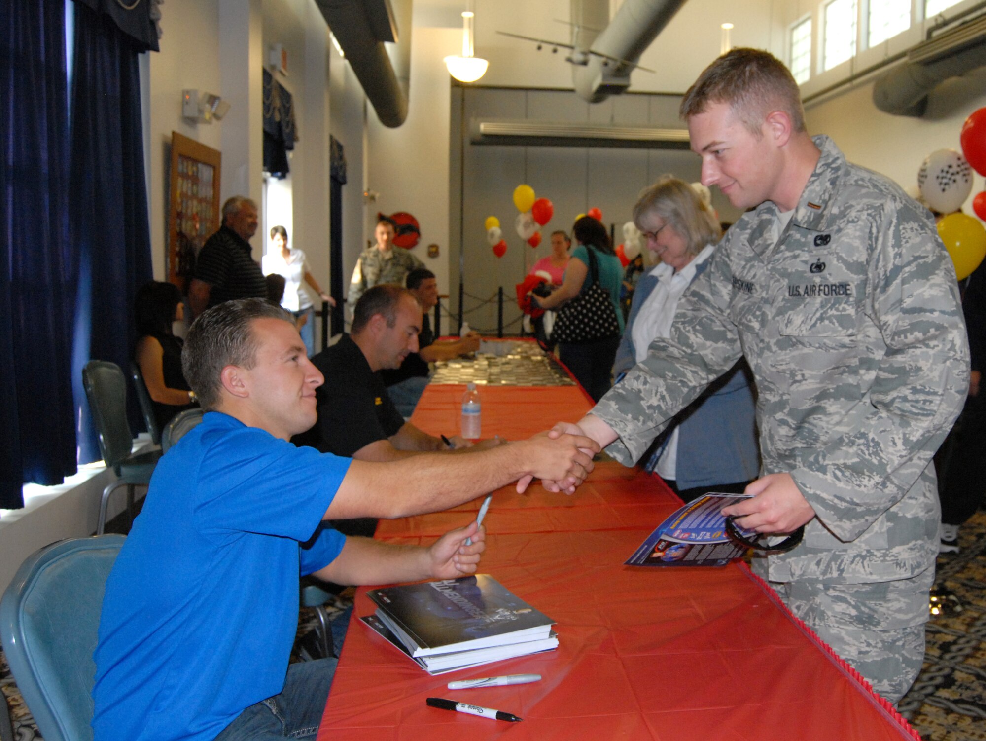 A.J. Allmendinger shake hands with 2nd Lt. Robert Erskine III May 13, 2011, at the NASCAR Social hosted at The Landings Club on Dover Air Force Base, Del. Mr. Allmendinger drives the No. 43 car co-sponsored by the U.S. Air Force. (Courtesy photo by April Crampton)