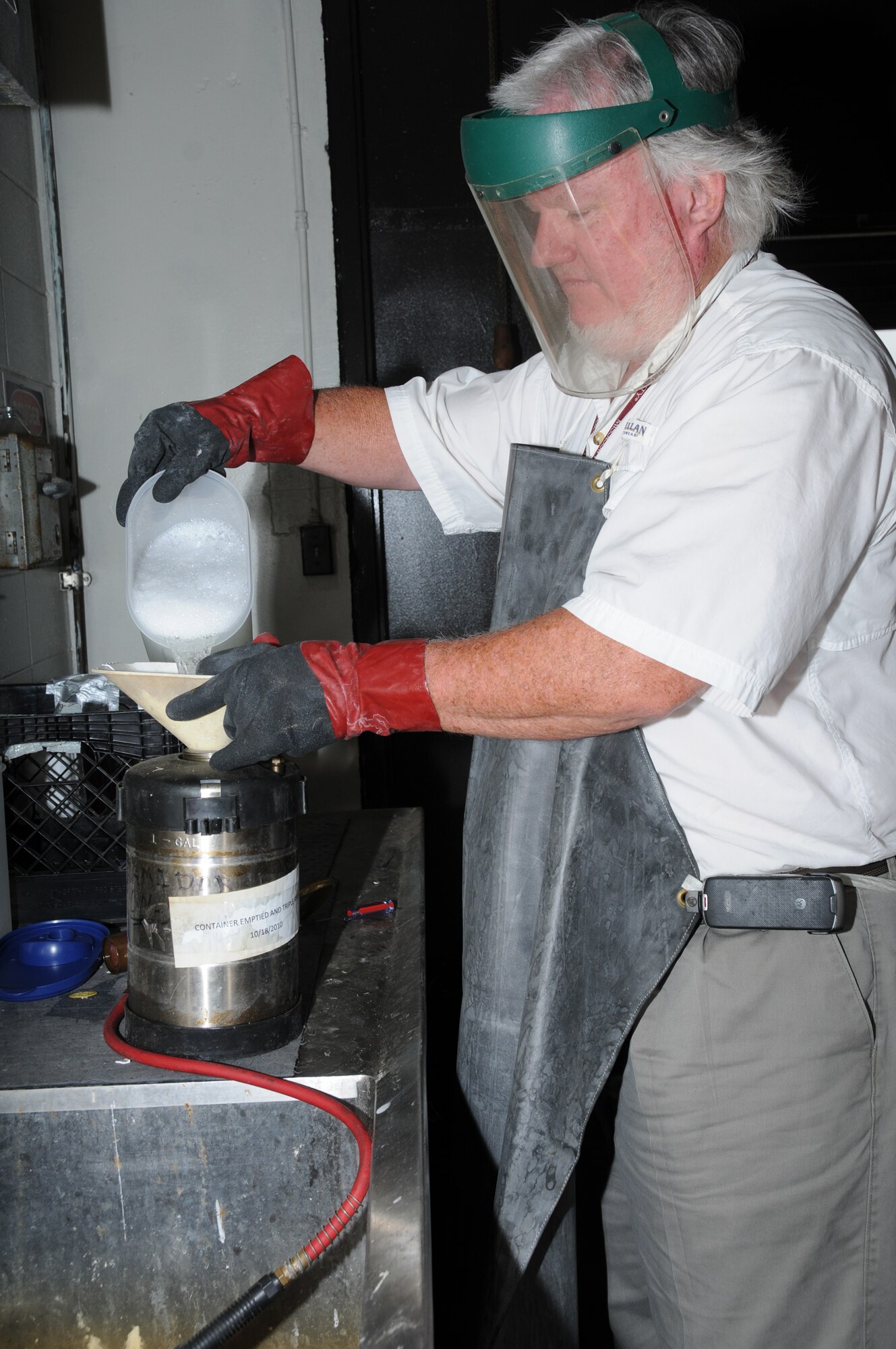 Mr. Remel mixes insecticide for use around the base.  (U.S. Air Force photo by Kemberly Groue)