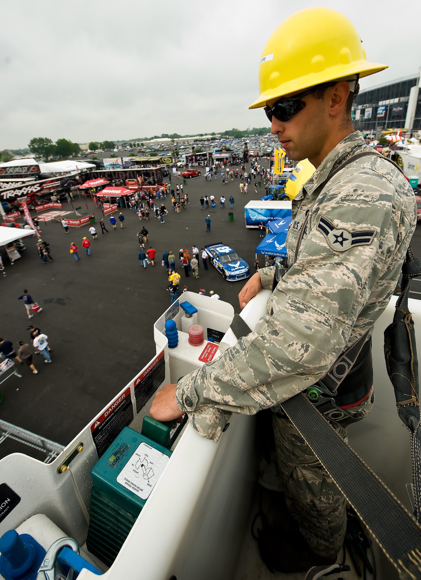Airman 1st Class Joseph Walters, 436th Civil Engineer Squadron electrician, operates a bucket truck May 15, 2011 at the United Services Organization Military Village at Dover International Speedway, Del. Airman Walters showcased his job for the community at the USO Military Village as part of the NASCAR weekend festivities. (U.S. Air Force photo by Airman 1st Class Jacob Morgan)
