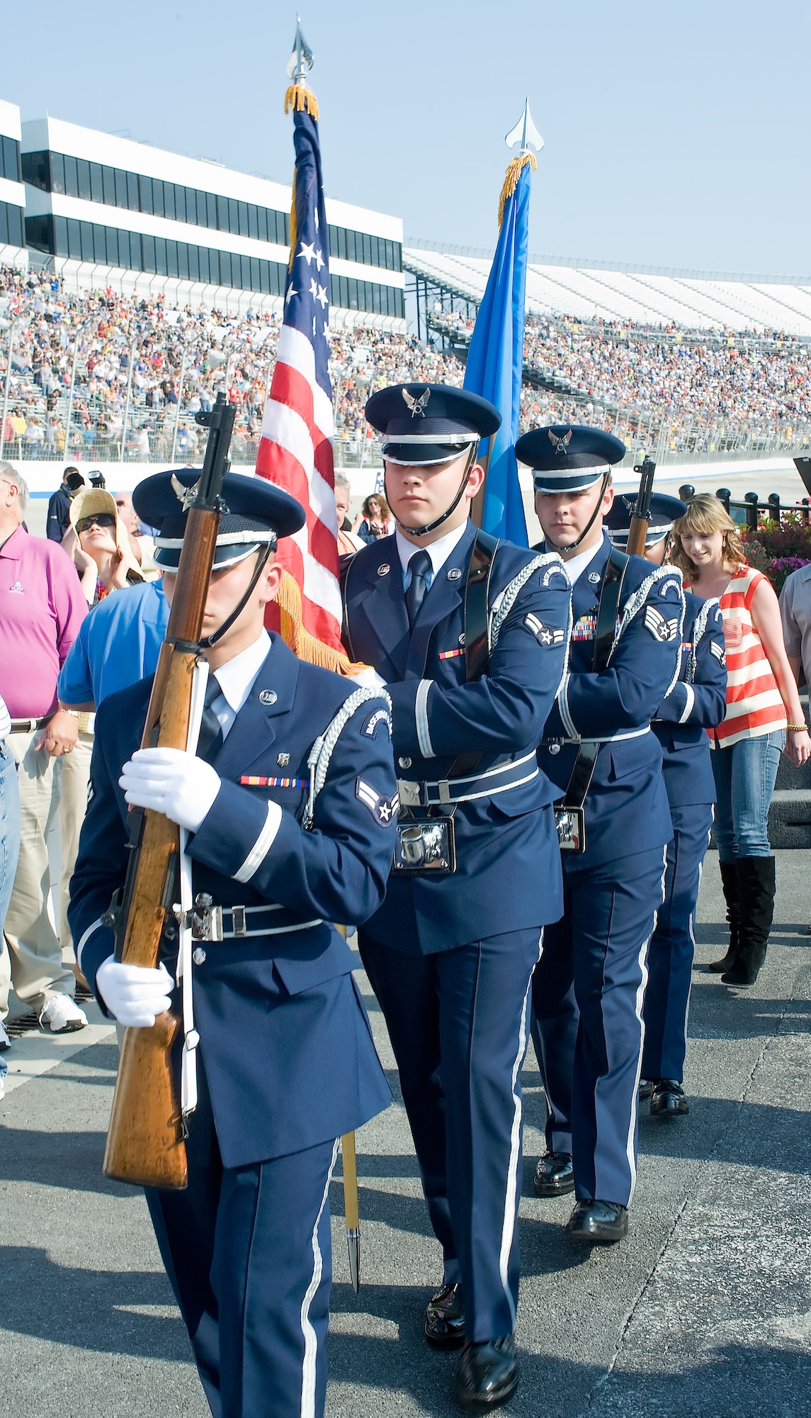 Honor Guard members from Dover Air Force Base, Del., march off the stage after the National Anthem was played May 13, 2011, at Dover International Speedway, Del. Air Force Honor Guard members were present each day of the races. (U.S. Air Force photo by Airman 1st Class Samuel Taylor)