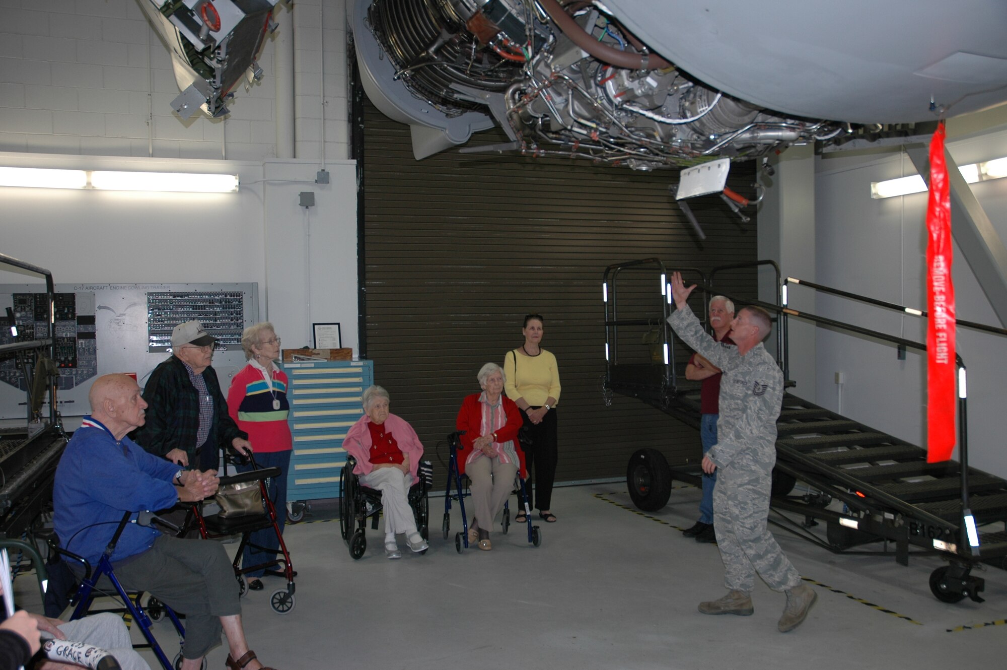 Technical Sergeant Lowery explains how the C-17 Globemaster III engines work to the members of Sweetgrass Retirement Village.