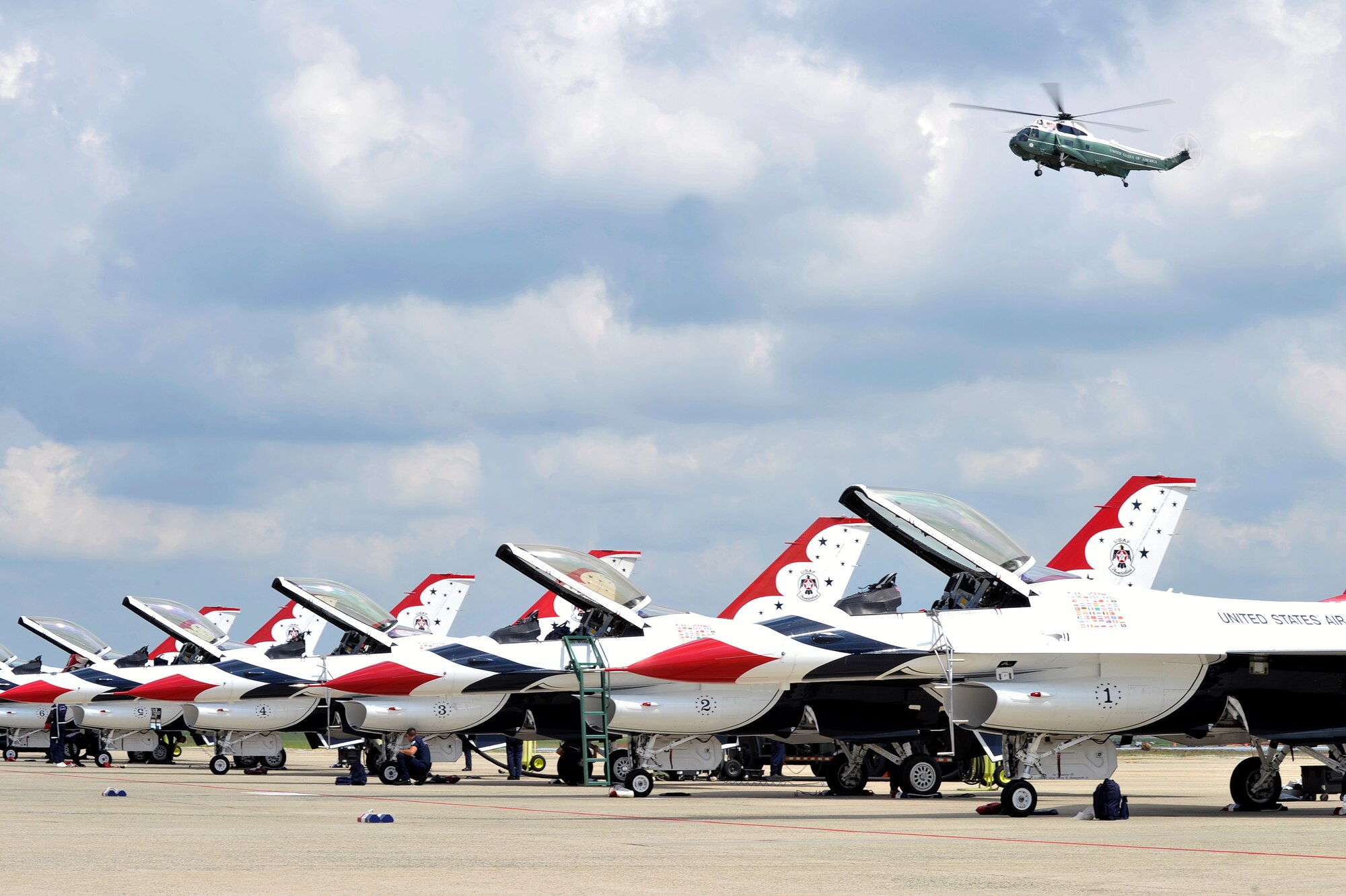 A VH-3D Sea King Helicopter, from Marine Helicopter Squadron One flies over the United States Air Force Thunderbirds after arriving here prior to the Joint Service Open House May 16. The JSOH is a three-day air show that gives local community members a closer look at the advanced capabilities of the military services. (U.S. Air Force Photo by Senior Airman Perry Aston) (Released)