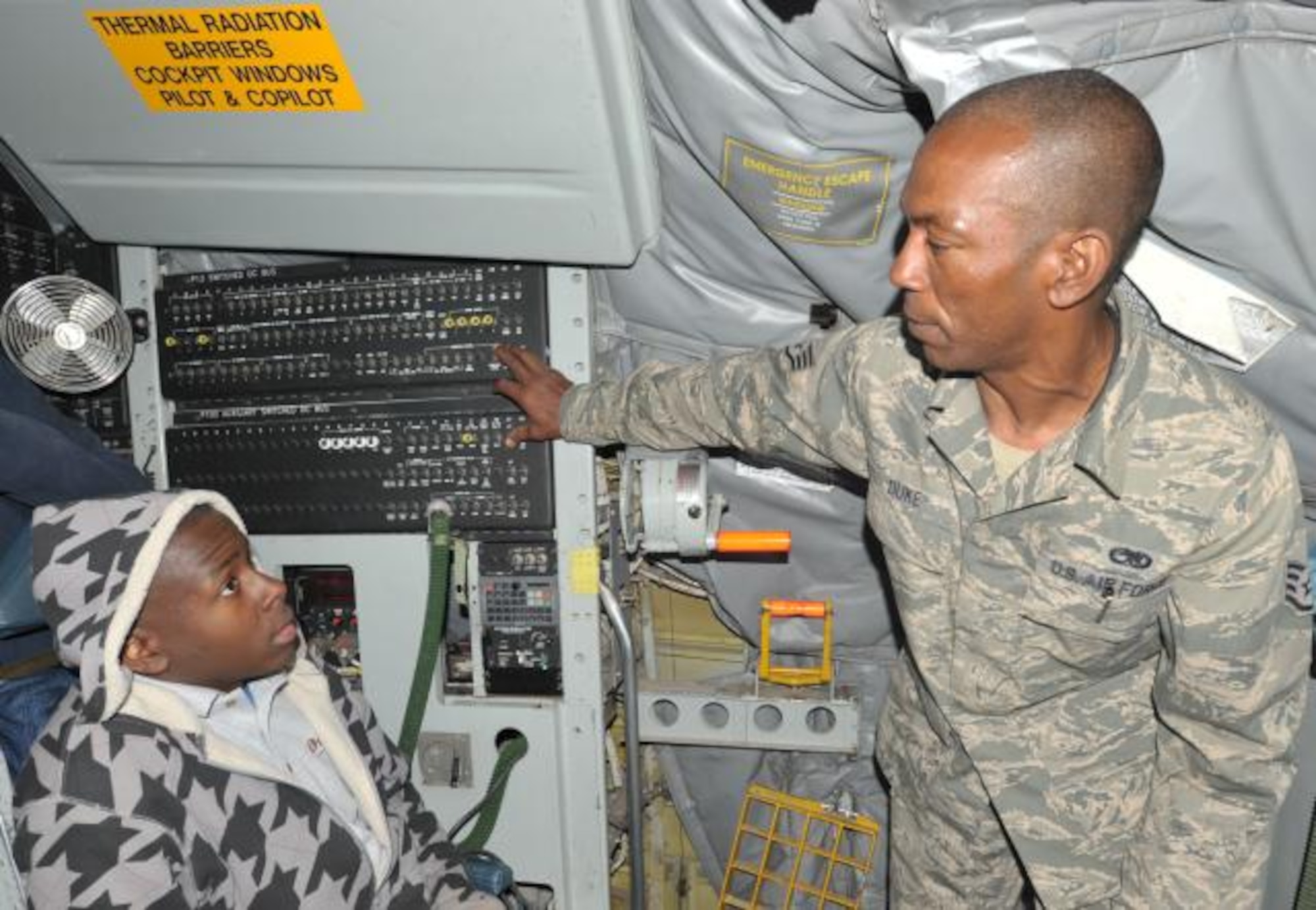Staff Sgt. John Duke, a maintainer with the 931st Air Refueling Group tells a Boys and Girls Club member about the capabilities of the KC-135 Stratotanker. (Air Force Photo by Staff Sgt. Carrie Peasinger)