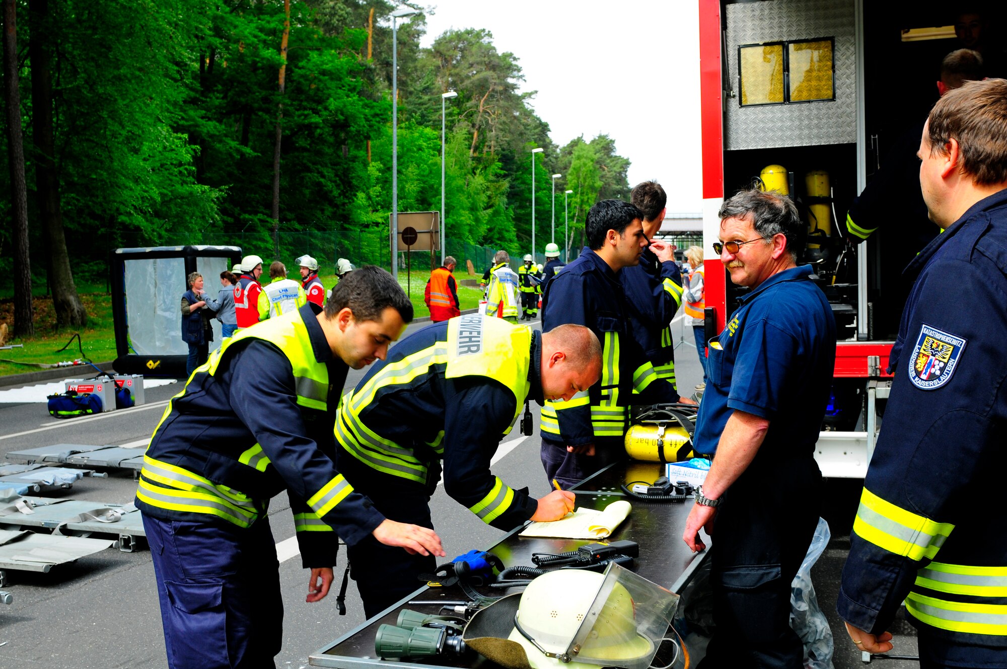Local firefighters prepare to assist casualities during an operational readiness exercise on Ramstein Air Base, Germany, May 17, 2011. More than 100 German first responders and observers participated in the 86th Airlift Wing and 435th Air Ground Operations Wing hosted exercise May 16 to 19. An ORE incorporates a series of scenarios to evaluate a base's ability to execute operational duties under simulated wartime conditions. (U.S. Air Force Photo by Airman 1st Class Brea Miller)