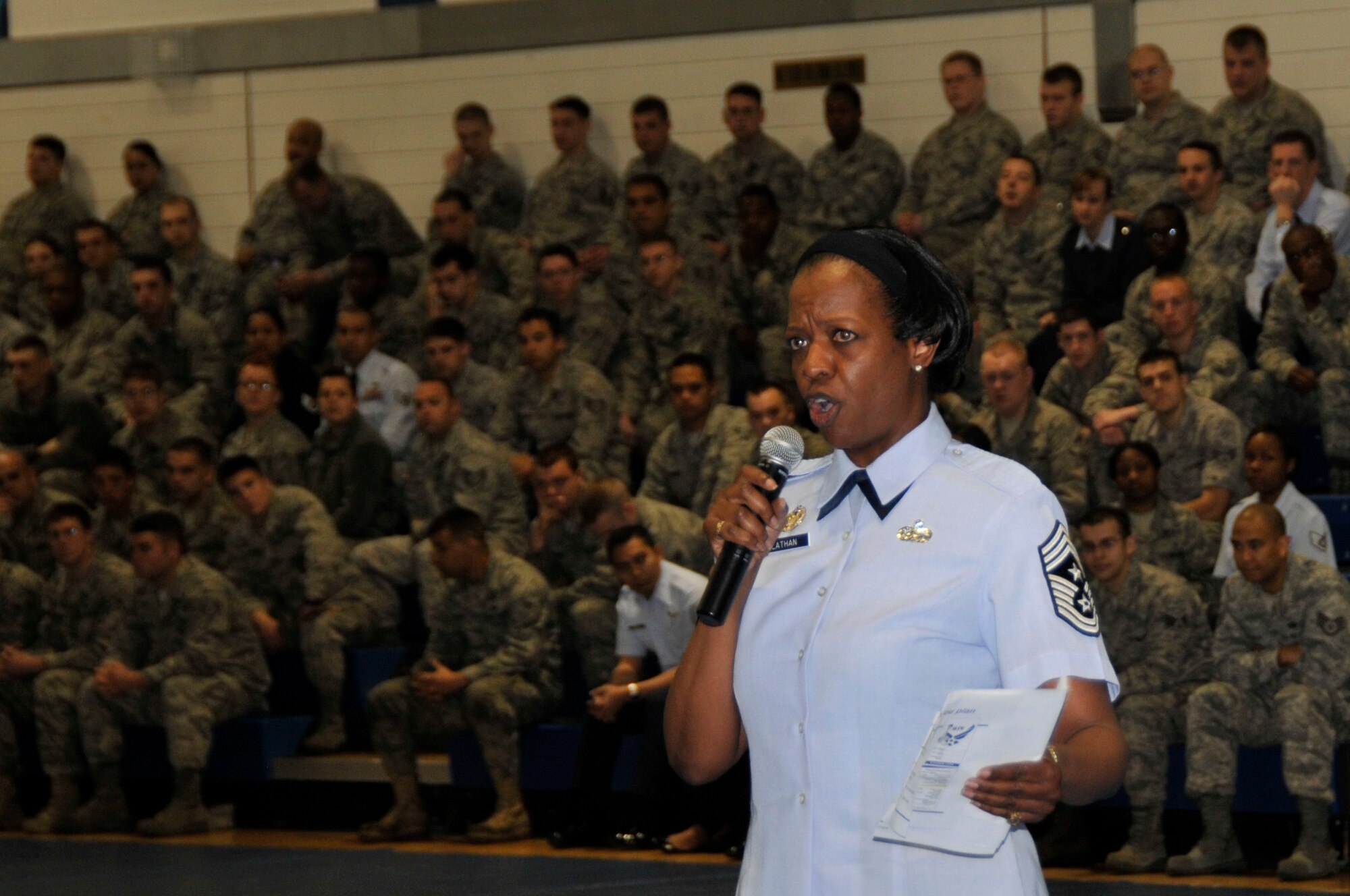 ROYAL AIR FORCE LAKENHEATH, England-- Chief Master Sgt. SaRita Lathan, 48th Fighter Wing command chief, briefs Liberty Warriors at the Lakenheath Fitness Center May 16, 2011. Chief Lathan held a mandatory All-Call for grades E-5 and below to discuss standards and expectations. During the call multiple Airmen shared their life challenges and experiences with the group. (U.S. Air Force photo/Senior Airman Eboni Reams)