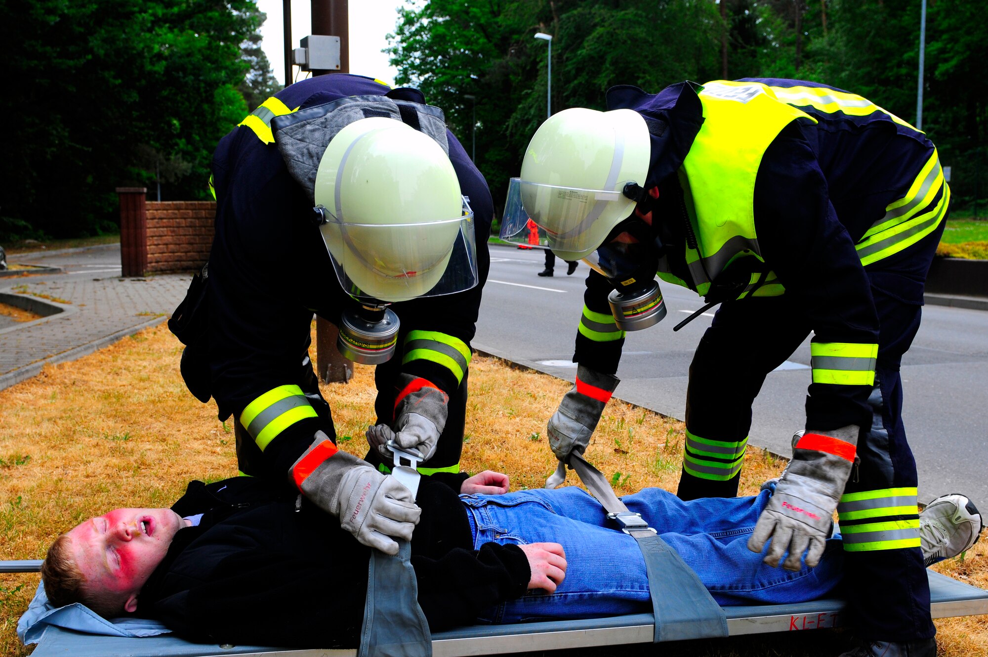 Local firefighters prepare to litter carry a casuality during an operational readiness exercise on Ramstein Air Base, Germany, May 17, 2011. More than 100 German first responders and observers participated in the 86th Airlift Wing and 435th Air Ground Operations Wing hosted exercise May 16 to 19. An ORE incorporates a series of scenarios to evaluate a base's ability to execute operational duties under simulated wartime conditions. (U.S. Air Force Photo by Airman 1st Class Brea Miller)