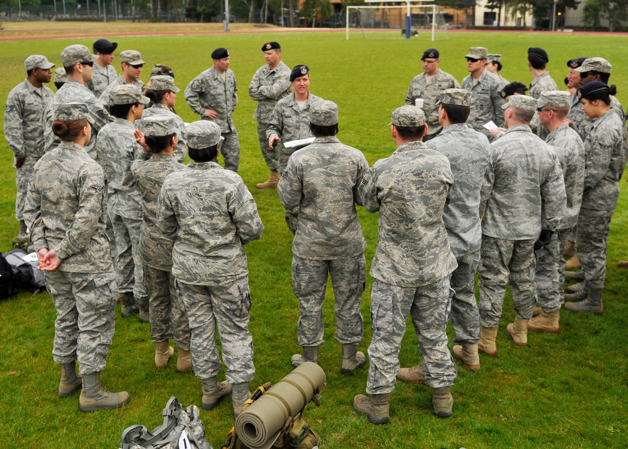 ROYAL AIR FORCE LAKENHEATH, England – Tech. Sgt. Tina Harem, 48th Security Forces Squadron NCO in charge of Plans, briefs teams about the impending obstacles during the 5K Combat Ruck March Challenge on May 17, 2011. This is one of several events that will be held during National Police Week at RAF Lakenheath to honor police officers. The challenge required the teams to race between four checkpoints: 25 push-ups, high crawl, memory game and fireman carry. (U.S. Air Force photo/Senior Airman Tiffany M. Deuel)