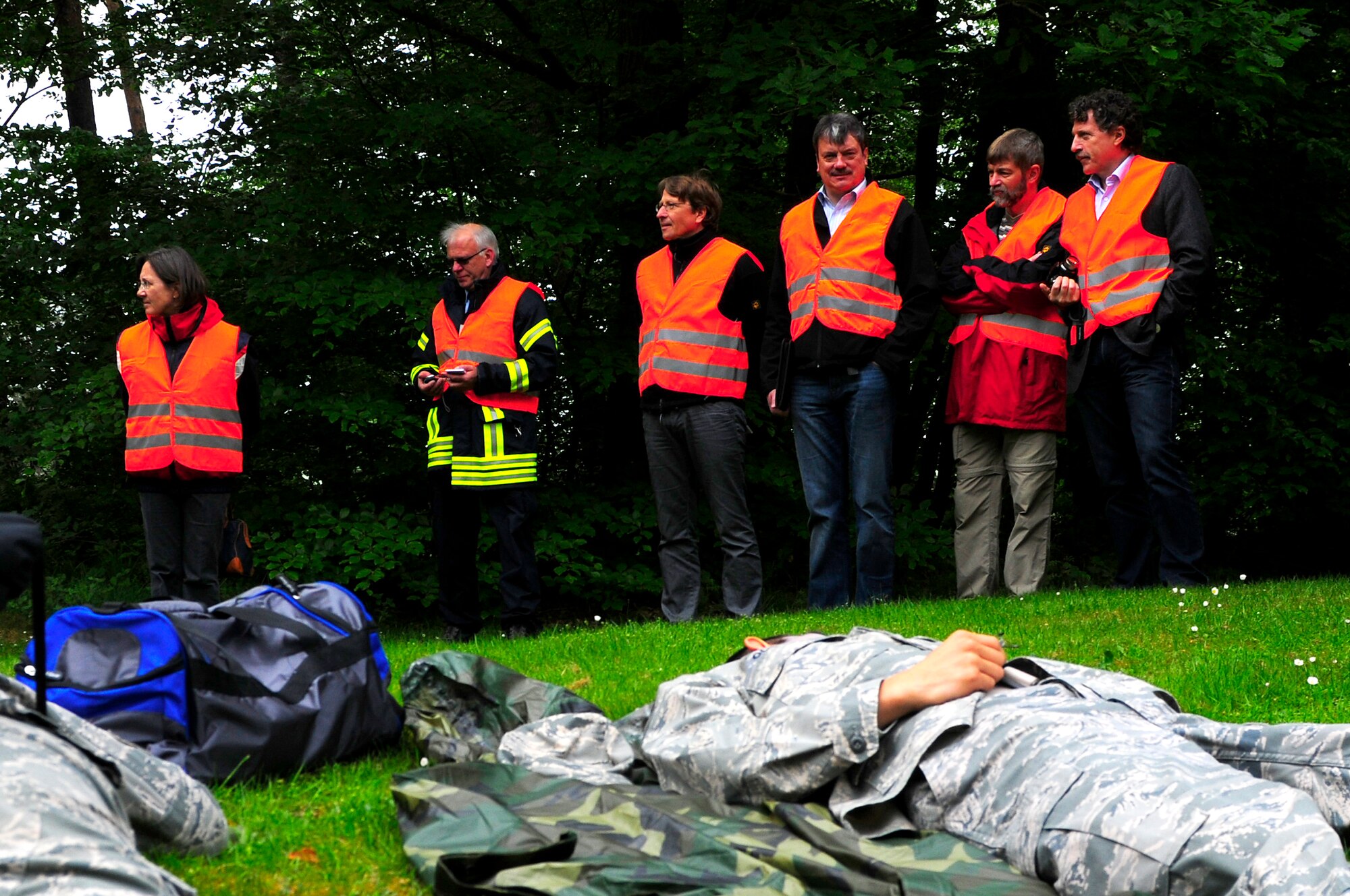 Host nation observers wait for first responders to tend to casualities during an operational readiness exercise on Ramstein Air Base, Germany, May 17, 2011. More than 100 German first responders and observers participated in the 86th Airlift Wing and 435th Air Ground Operations Wing hosted exercise May 16 to 19. An ORE incorporates a series of scenarios to evaluate a base's ability to execute operational duties under simulated wartime conditions. (U.S. Air Force Photo by Airman 1st Class Brea Miller)