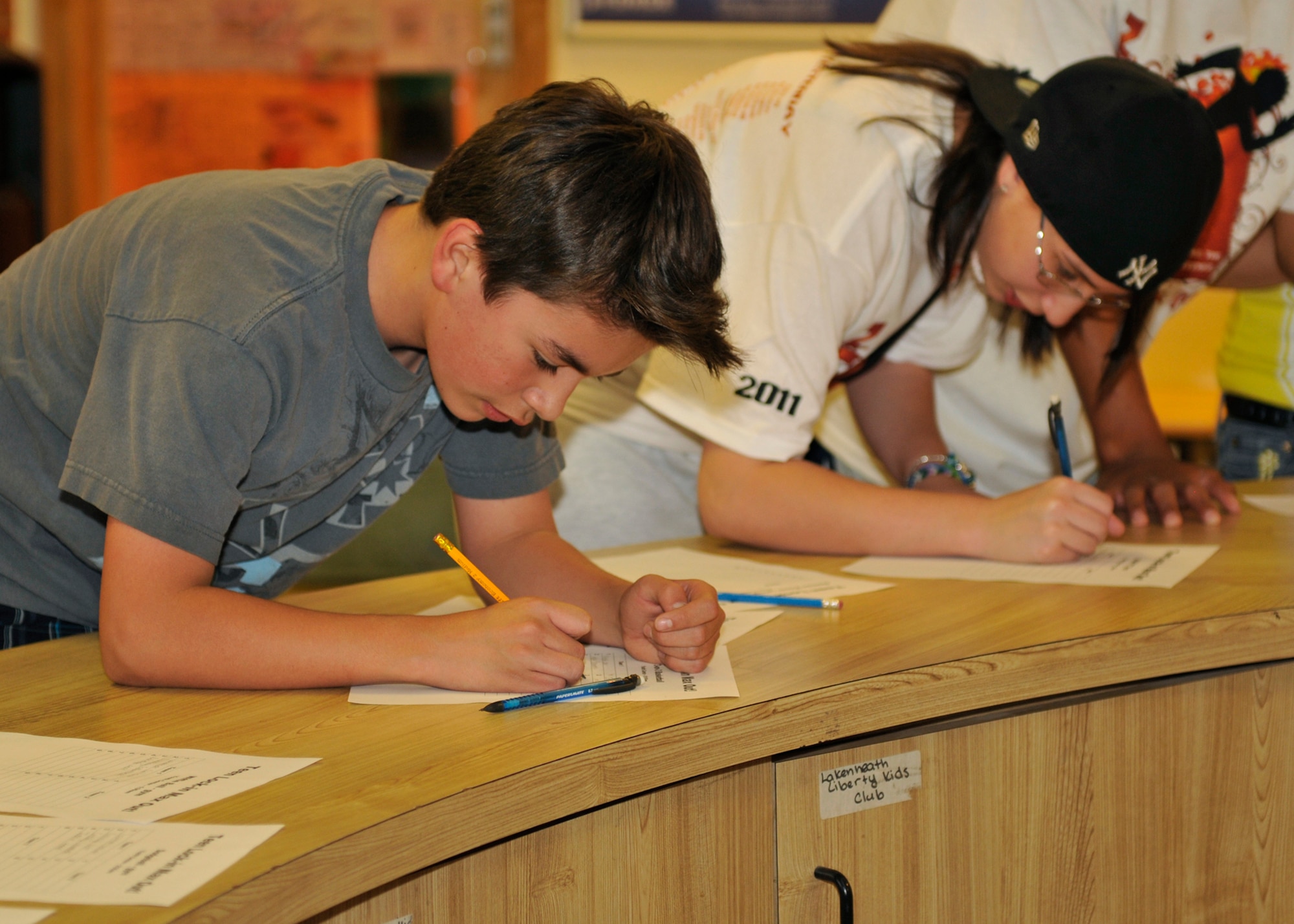 ROYAL AIR FORCE LAKENHEATH, England - Ernie Evans and Clarissa Wood, Lakenheath Intermediate School 8th graders, sign up for events during a "Teen Lock-In Max Out" at the RAF Lakenheath Youth Center on May 13, 2011. Students spent the night participating in basketball, wallyball, a mock Air Force physical training test and various other activities.Nearly 70 bases participated in the Air Force-wide event. During the event, the bases could call and challenge another base to various events, such as who could perform the most push-ups or free throws in a minute. (U.S. Air Force photo/Senior Airman Tiffany M. Deuel)