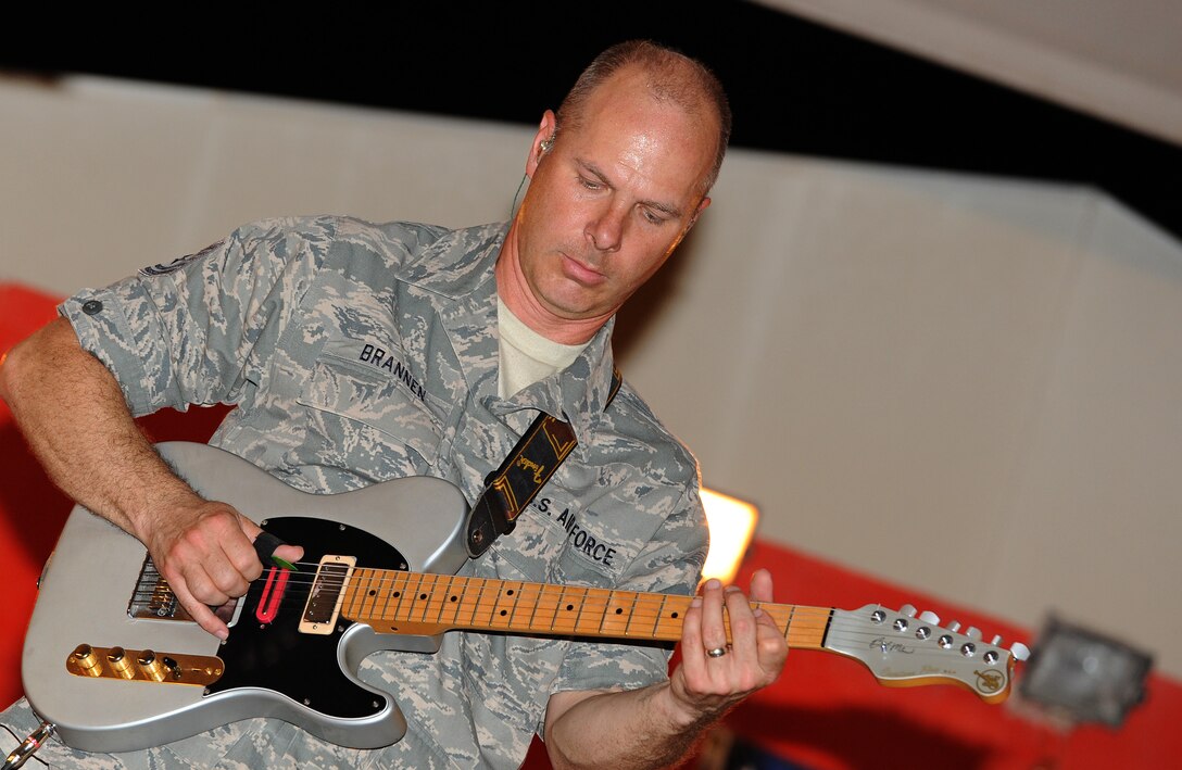 Tech. Sgt. Stephen Brannen of "Wild Blue Country" U.S. Air Forces Central Band, plays the guitar during a concert for troops at an undisclosed location in Southwest Asia, May 16. (U.S. Air Force photo/Staff Sgt. Liliana Moreno)                          