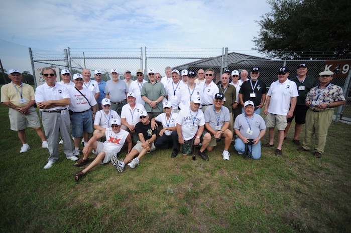 Veteran K-9 handlers from the 50th Air Police Squadron, Hahn Air Base, Germany, pose for a group photo after touring the kennels and watching a military working dog demonstration given by the 628th Security Forces Squadron on Joint Base Charleston, May 14. (U.S. Air Force photo/Staff Sgt. Nicole Mickle)  