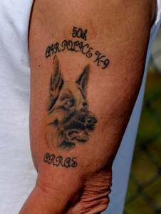 Bob Wallum proudly displays his tattoo memorializing Arras, a military working dog that was assigned to him while he was part of the 50th Air Police Squadron's K-9 section at Hahn Air Base, Germany in the 1960s.  Mr. Wallum is one of 32 veterans who attended the unit's 50-year reunion on Joint Base Charleston. (U.S. Air Force photo/ Staff Sgt. Nicole Mickle)  