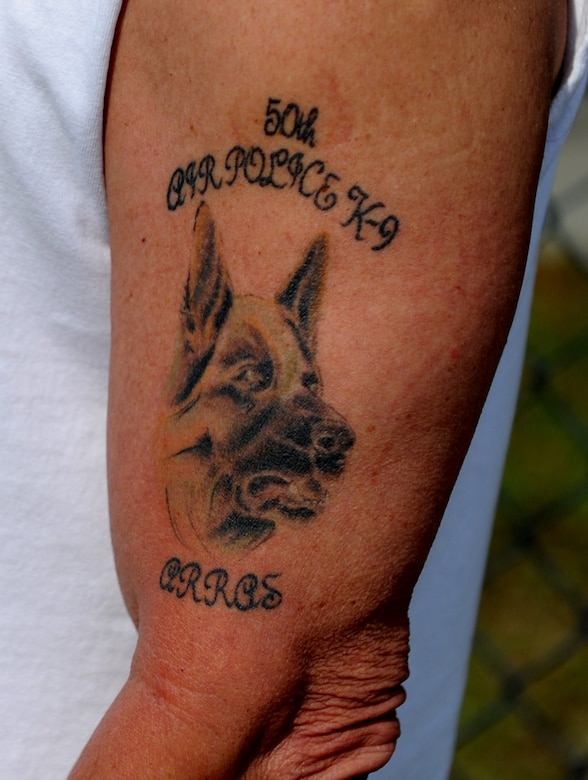Bob Wallum proudly displays his tattoo memorializing Arras, a military working dog that was assigned to him while he was part of the 50th Air Police Squadron's K-9 section at Hahn Air Base, Germany in the 1960s.  Mr. Wallum is one of 32 veterans who attended the unit's 50-year reunion on Joint Base Charleston. (U.S. Air Force photo/ Staff Sgt. Nicole Mickle)  