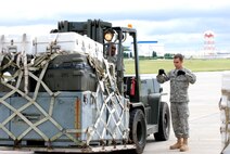 Senior Airman Daniel Peterson guides Staff Sgt. William Walker on the marshalling of a pallet during a training exercise at Dobbins Air Reserve Base.  Both Airmen are air transportation specialists with the 80th Aerial Port Squadron.  (U.S. Air Force photo/Master Sgt. Stan Coleman)