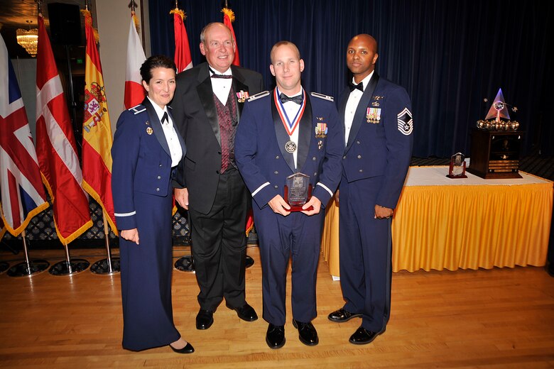 Capt. Damian Ochs (third from left), 4th Space Control Squadron, received the Gen. Lance W. Lord Superior Space Operational Leadership Award, officer category, April 21. The award is presented each year to personnel who have made significant contributions to the 21st OG mission through job performance, professionalism and dedication. Also pictured are (left to right) Col. Nina Armagno, 21st Operations Group commander, retired Gen. Lance Lord, and Senior Master Sgt. Lavon Coles, 21st OG superintendent. (U.S. Air Force photo/Dennis Howk)