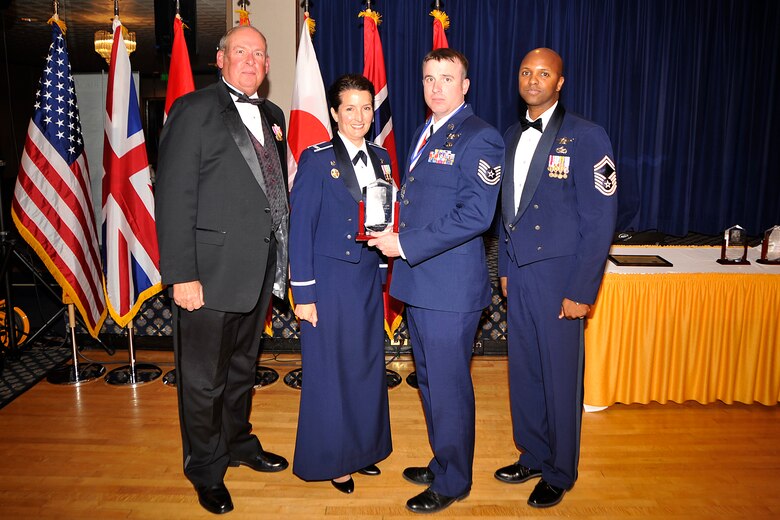 Tech. Sgt. Harold Mosley (third from left), 76th Space Control Squadron, received the Gen. Lance W. Lord Superior Space Operational Leadership Award, enlisted category, April 21. The award is presented each year to personnel who have made significant contributions to the 21st OG mission through job performance, professionalism and dedication. Also pictured are (left to right) retired Gen. Lance Lord, Col. Nina Armagno, 21st Operations Group commander, and Senior Master Sgt. Lavon Coles, 21st OG superintendent. (U.S. Air Force photo/Dennis Howk)