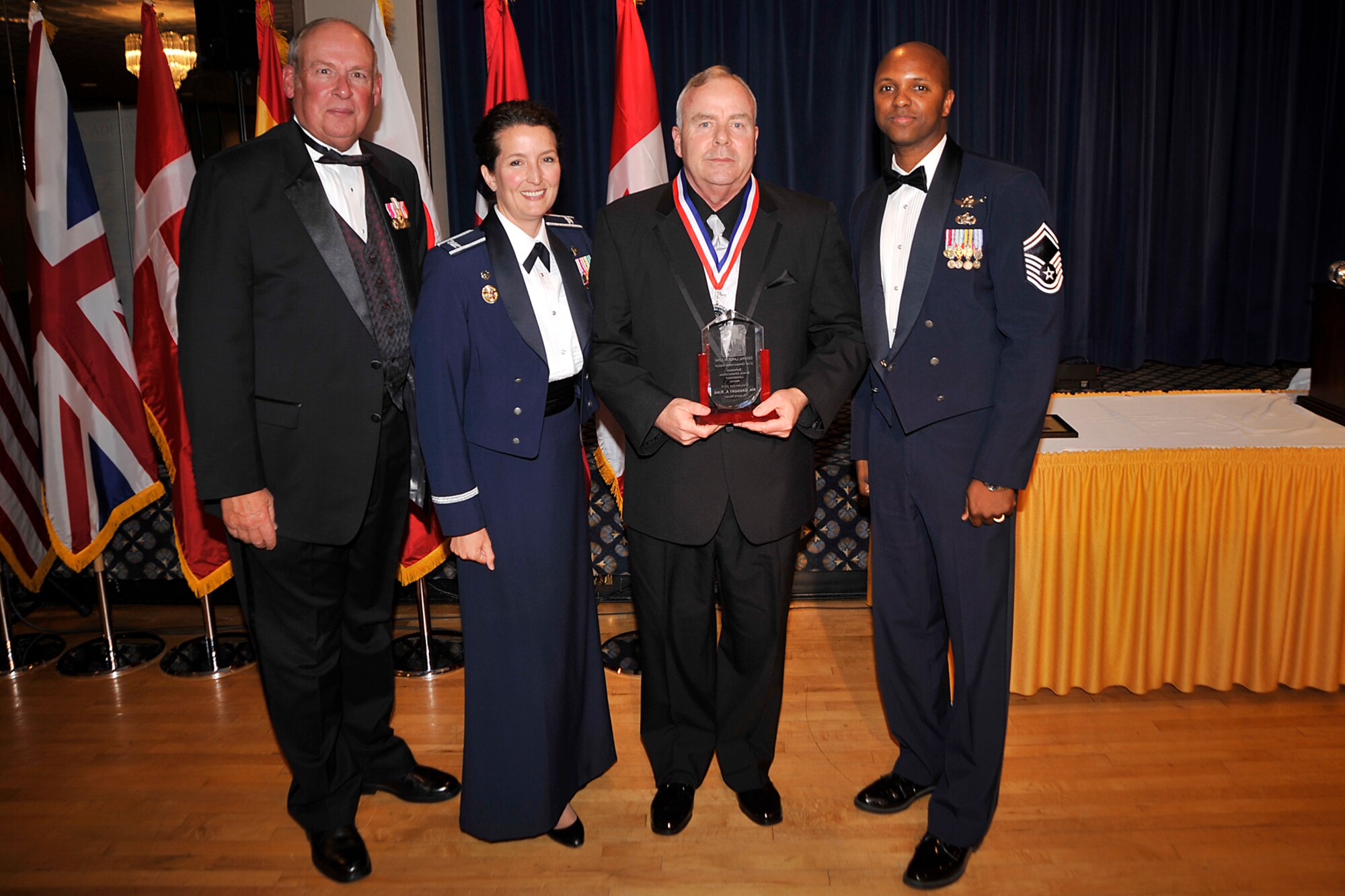 Gregory King (third from left), 21st Operations Support Squadron, received the Gen. Lance W. Lord Superior Space Operational Leadership Award, civilian category, April 21. The award is presented each year to personnel who have made significant contributions to the 21st OG mission through job performance, professionalism and dedication. Also pictured are (left to right) retired Gen. Lance Lord, Col. Nina Armagno, 21st Operations Group commander, and Senior Master Sgt. Lavon Coles, 21st OG superintendent. (U.S. Air Force photo/Dennis Howk)
