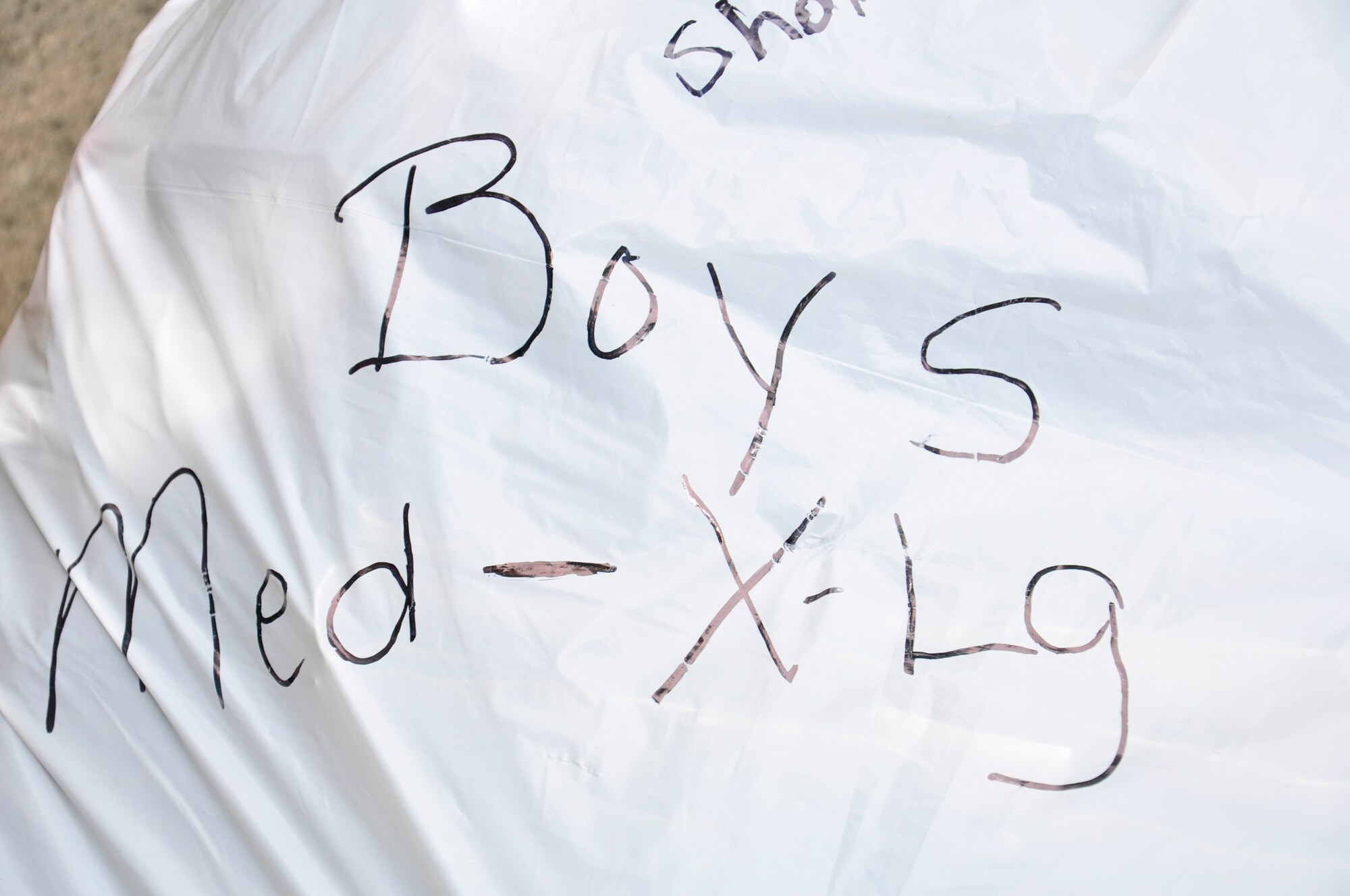 A bag of children's clothing is labeled for quick distribution and awaits pick-up at the tornado relief collection point May 13, 2011, Hurlburt Field, Fla. The Hurlburt Field community collected more than 9,000 pounds of clothes, shoes, pots, pans, toys and camping equipment May 4-13 to benefit the survivors of the April 27, 2011 tornado outbreak that devasted cities across six states. (U.S. Air Force photo by Staff Sgt. Sarah Martinez/RELEASED)