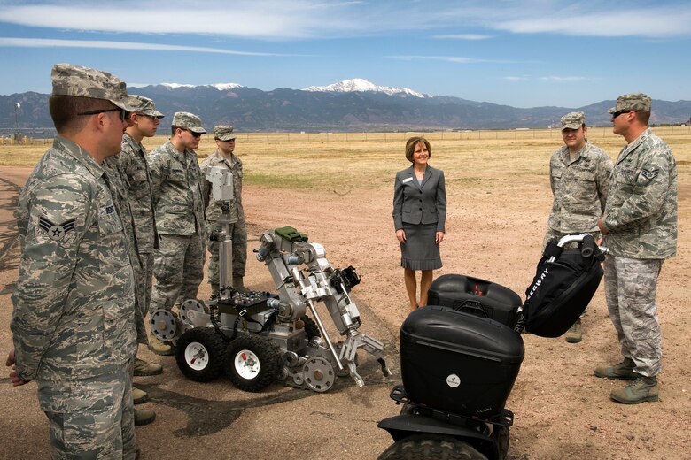 PETERSON AIR FORCE BASE, Colo – Staff Sgt. Dan Rosemier, 21st Civil Engineer Squadron Explosive Ordnance Disposal Flight, (far right) briefs El Paso County Commissioner District 5 Peggy Littleton (center) on the specific EOD response capabilities they possess for base and off-base crisis events May 9. Base emergency responders briefed Commissioner Littleton on the mutual-aid capability and processes in the event of a city or county emergency. The purpose of these orientations is to educate and inform key public officials on the role and effect our installation’s emergency responders provide through the emergency operations center and a variety of response members under the incident commander. (U.S. Air Force photo/Craig Denton)