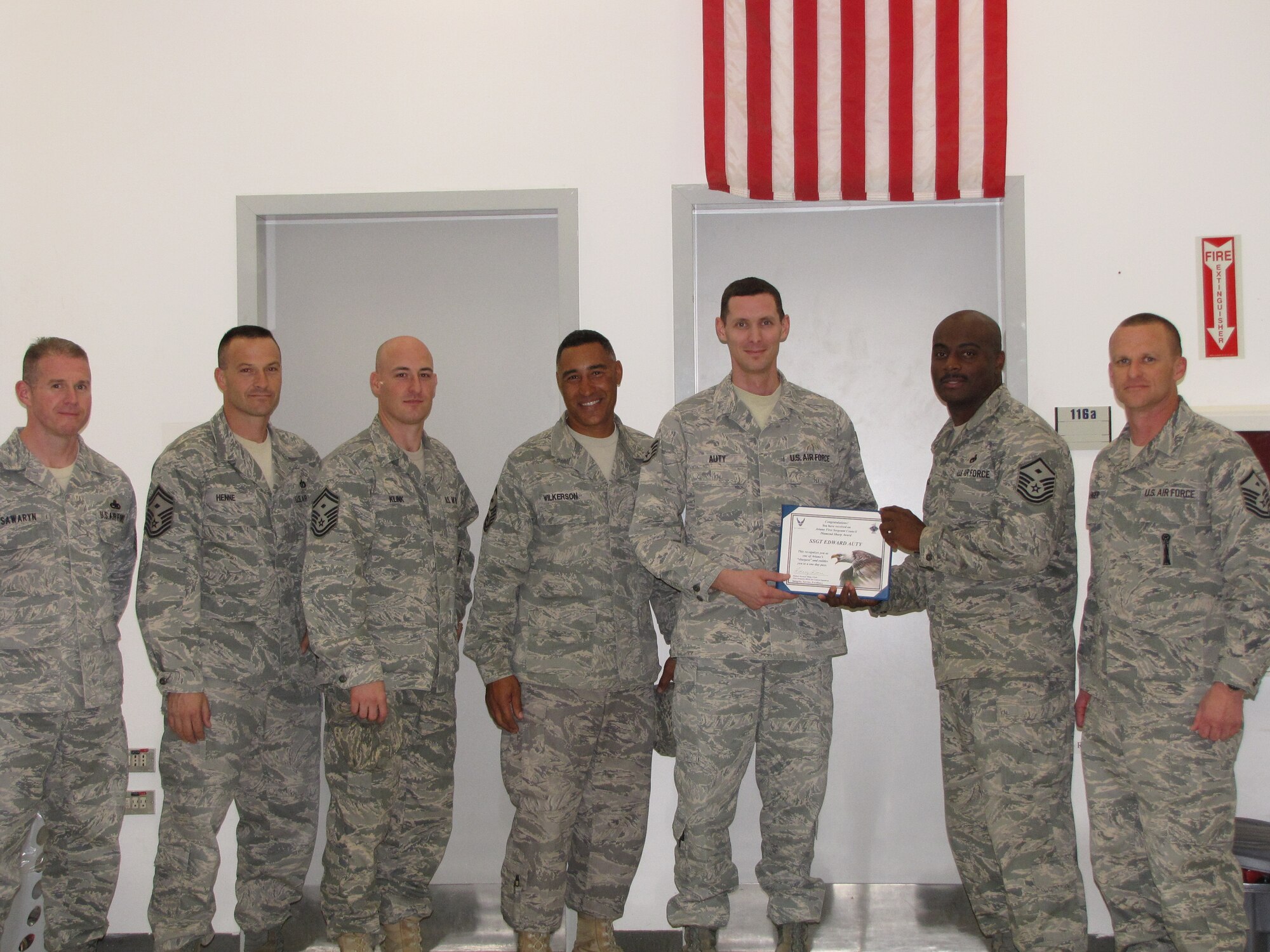 Staff Sgt. Edward Auty, 603rd Air Control Squadron readiness training instructor, is presented the Diamond Sharp award for October by the Aviano First Sergeants Council. The Diamond Sharp award is designed to recognize Aviano Airmen who distinguish themselves through outstanding professionalism, impeccable appearance and a "can do" attitude. (Courtesy photo)