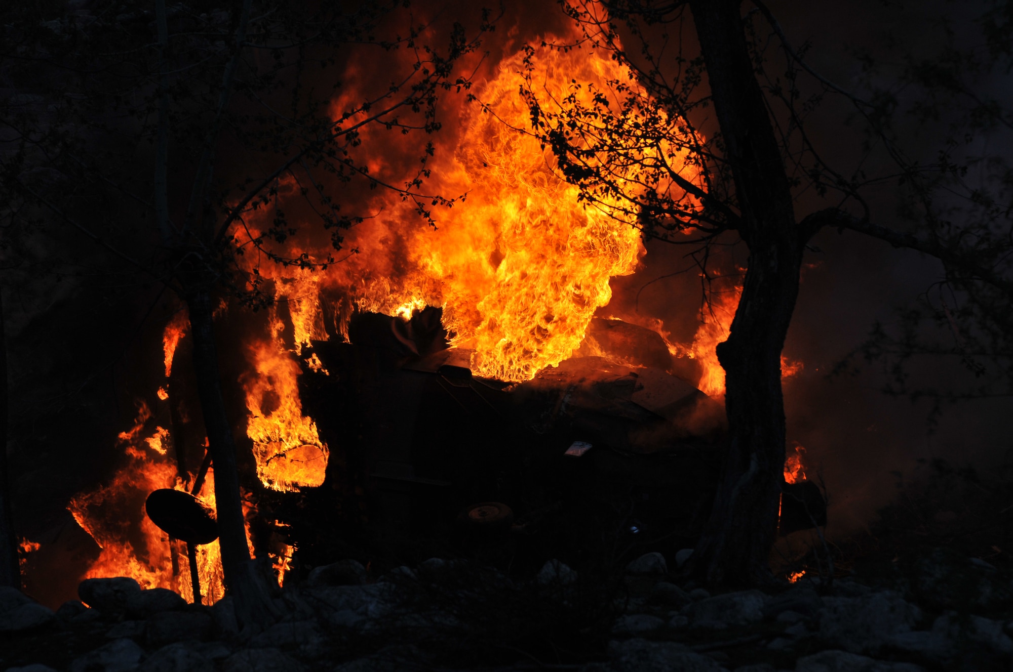 Nuristan,  Afghanistan. Army Pathfinders of Fox Company, 2nd Battalion, 10th Combat Aviation Brigade Fort Drum, NY watch as an Afghan Air Force Mi-17 helicopter burns from phosphorus grenades in the Nuristan province, Afghanistan. The Pathfinders were tasked to provide security around the perimeter and disassemble the crashed aircraft, and remove sensitve items to be sling loaded by a CH-47 Chinook and taken to an airbase. Photo by Tech Sgt. Brian E. Christiansen.