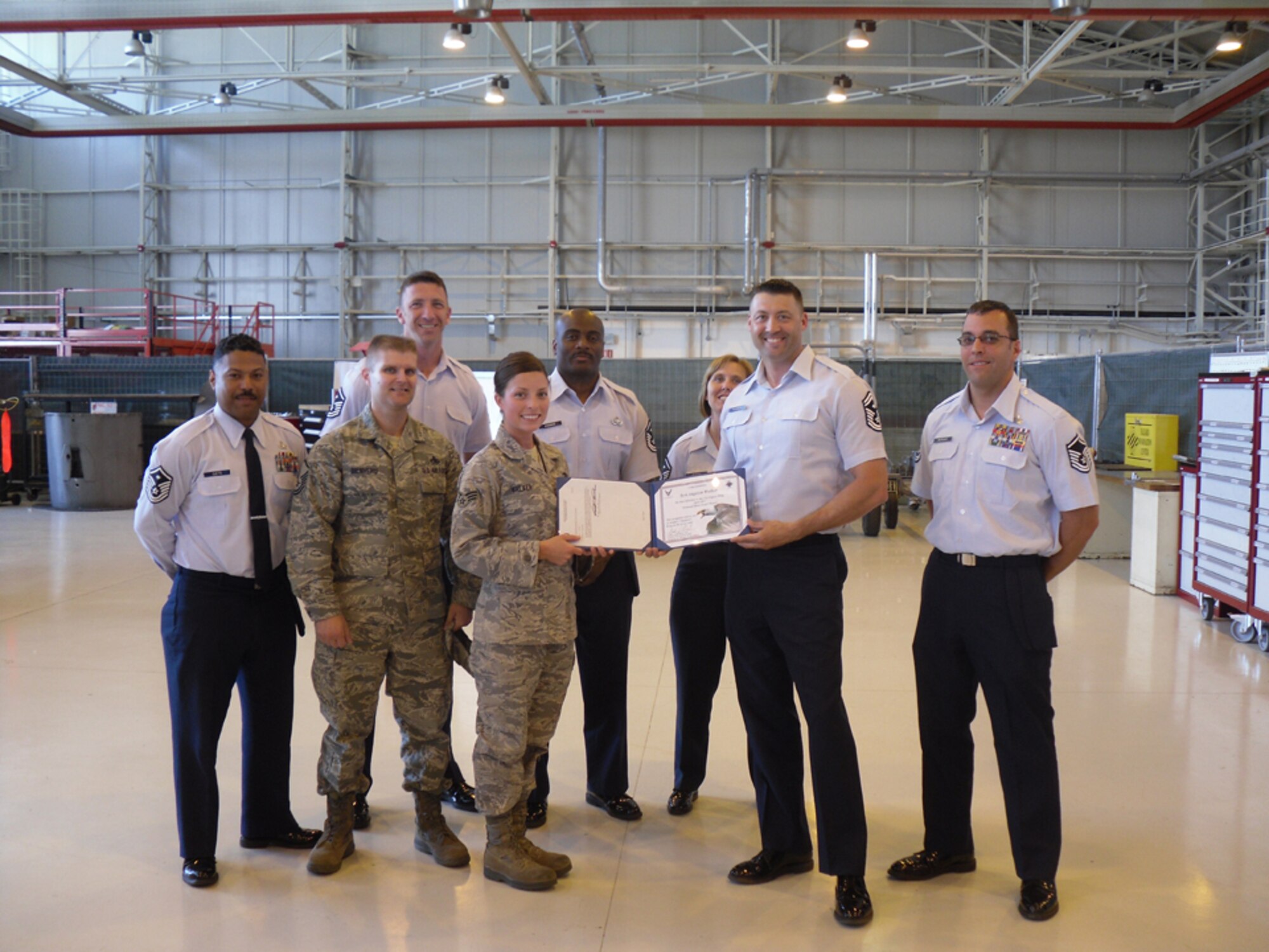 Senior Airman Angelyn Walker, 31st Maintenance Squadron phase dock inspector, is presented the Diamond Sharp award for April by the Aviano First Sergeants Council. The Diamond Sharp award is designed to recognize Aviano Airmen who distinguish themselves through outstanding professionalism, impeccable appearance and a "can do" attitude. (Courtesy photo)