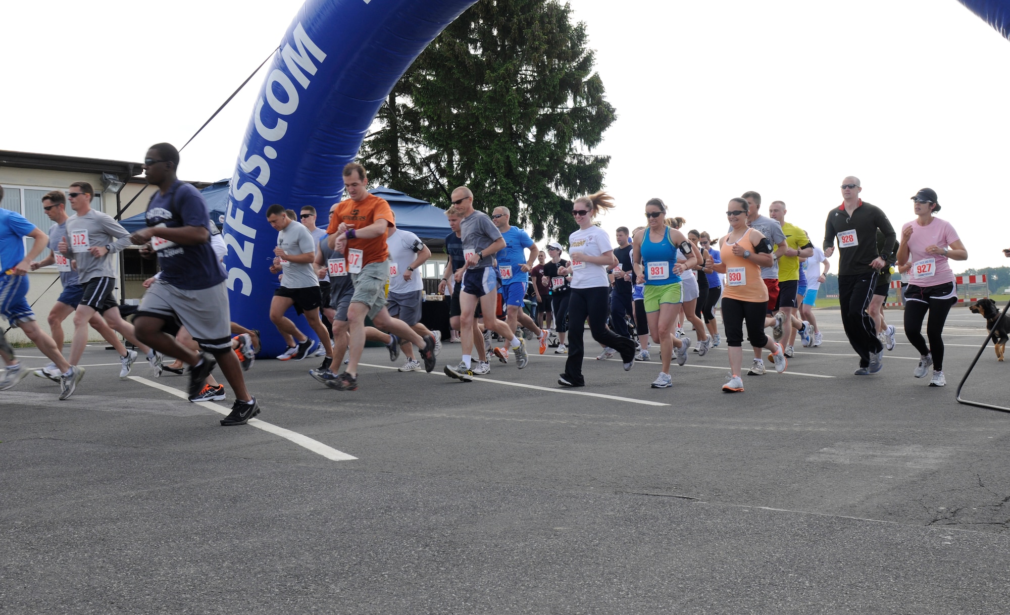SPANGDAHLEM AIR BASE, Germany – Runners take off from the starting line during the 10K and U.S. Air Forces in Europe half marathon in the parking lot behind the Skelton Memorial Fitness Center here May 14. The USAFE half marathon is an annual event Airmen from around Europe can participate in. Each run was split into different categories based on age and gender. (U.S. Air Force photo/Airman 1st Class Brittney Frees)