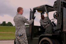 Senior Airman Cameron Janzen, instructs Staff Sgt. William Walker on forklift operation during an C-130 airlift training excercise on May 15.   Both Airmen are air transportation specialists and are assigned to the 80th Aerial Port Squadron's Ramp Services section.  Air Transporation specialists are responsible for the loading and unloading of cargo. Within the Air Force they are commonly referred to as "aerial porters" or "port dawgs."  (U.S. Air Force photo/Master Sgt. Stan Coleman)