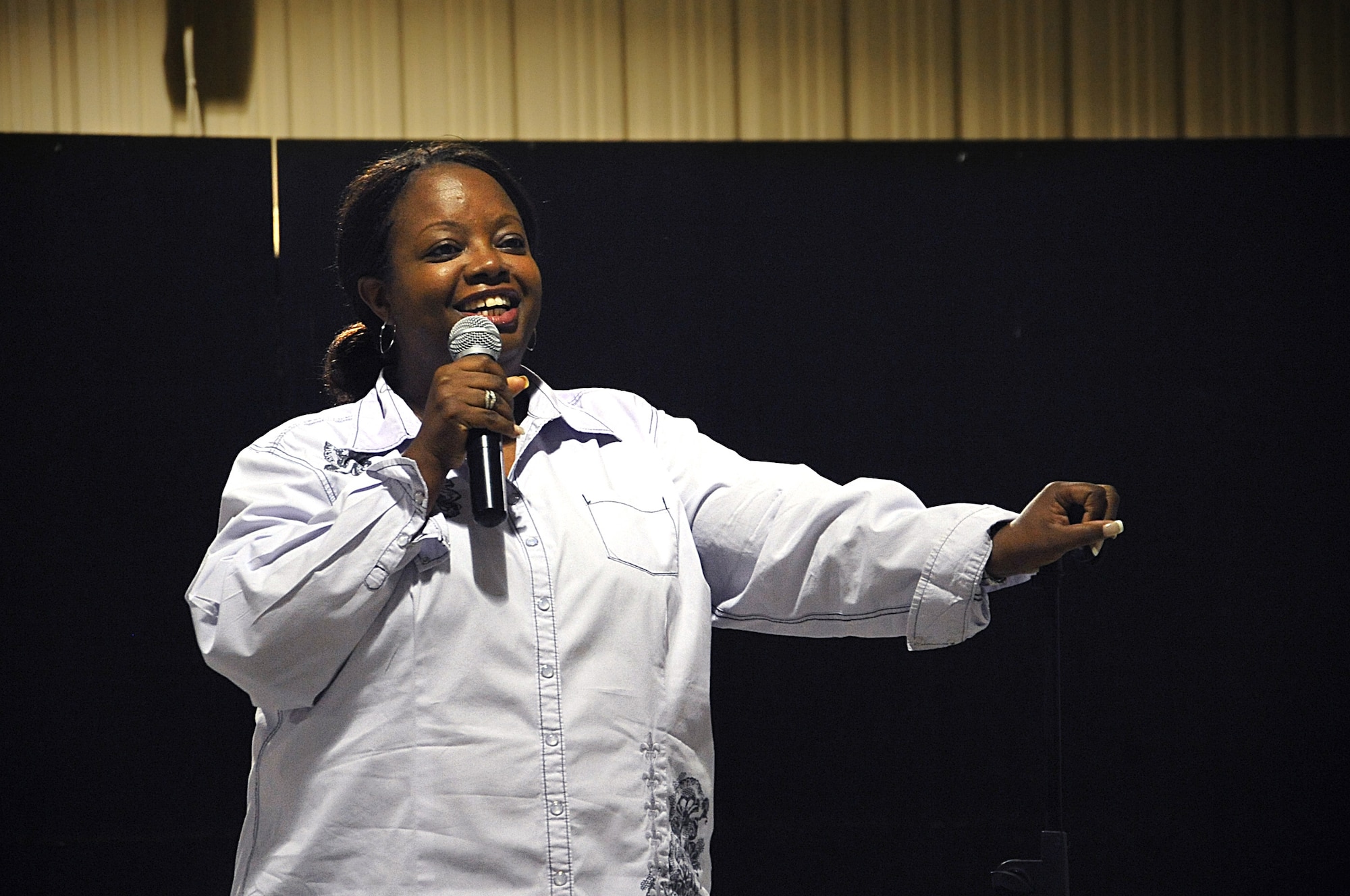 Alycia Cooper, along with Funny Girls April Macie and Jackie Kashian, performed stand-up comedy for the 386th Air Expeditionary Wing Airmen May 12. (U.S. Air Force photo by Senior Airman Cynthia Spalding)