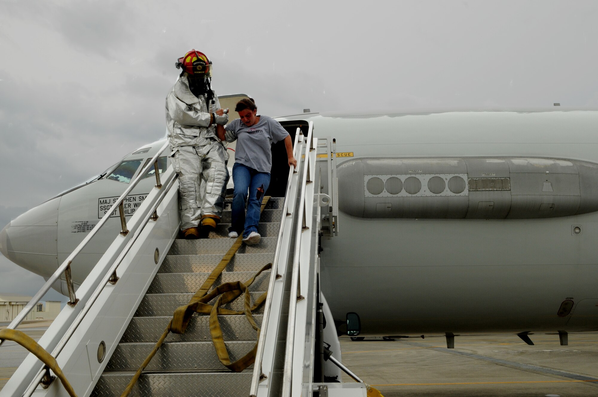 A fireman from the 18th Civil Engineer Squadron, extracts a simulated injured victim from an E-3 Sentry aircraft, which had an engine fire May 17 at at Kadena Air Base, Japan. The simulated engine fire was part of Beverly High 11-04, a local operational readiness exercise, and tested the fire department’s ability to respond to an aircraft fire. (U.S. Air Force photo/Airman 1st Class Jarvie Z. Wallace)