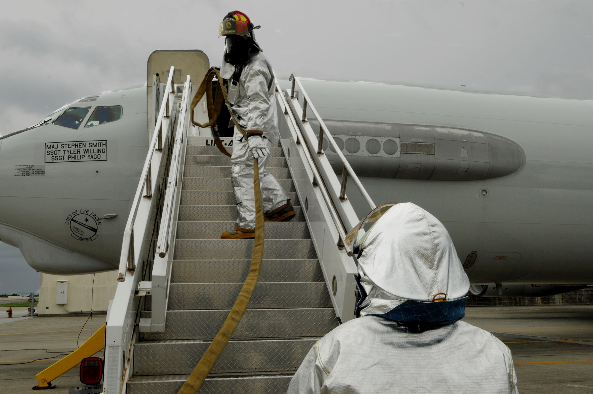 Firemen from the 18th Civil Engineer Squadron, enter  a  E-3 Sentry aircraft  to extinguish a simulated engine fire May 17 at Kadena Air Base, Japan. The simulated engine fire was part of Beverly High 11-04, a local operational readiness exercise, and it helped test the fire department’s ability to respond to an aircraft fire. (U.S. Air Force photo/Airman 1st Class Jarvie Z. Wallace)