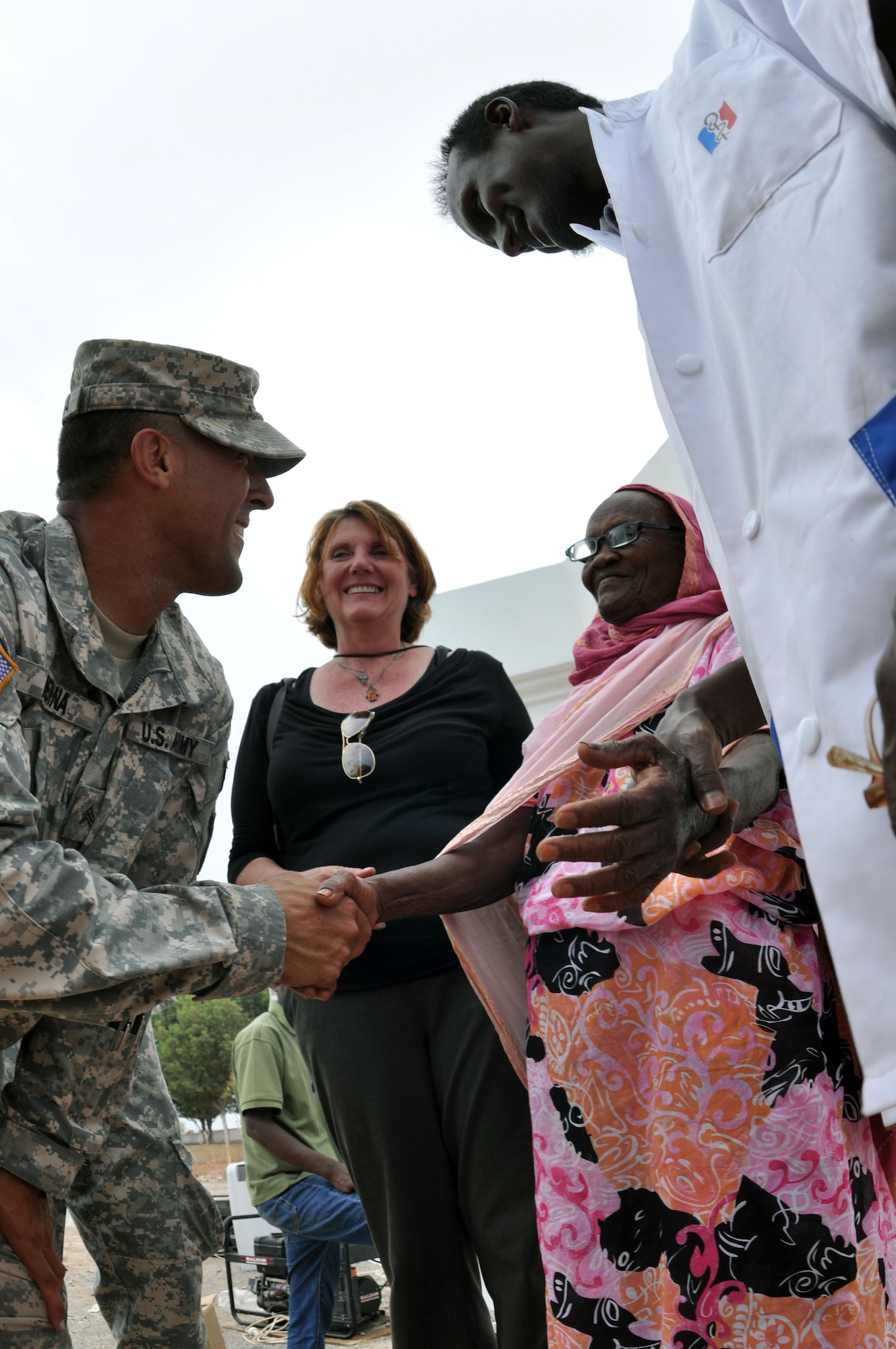 OBOCK, Djibouti - U.S. Army Sgt. Noel Medina escorts a patient who received new prescription eyeglasses during a recent Medical Capacity Program (MEDCAP) mission, May 5. Optometrists attached to Combined Joint Task Force – Horn of Africa (CJTF-HOA) performed vision wellness checks and provided prescription glasses to patients requiring eyesight correction. The MECAP also hosted dental and preventative care, and involved Djiboutian Health Ministry personnel, local care providers and 20 members of the JTF-HOA’s 402nd Civil Affairs Battalion. (U.S. Air Force photo by Lt. Col. Leslie Pratt)