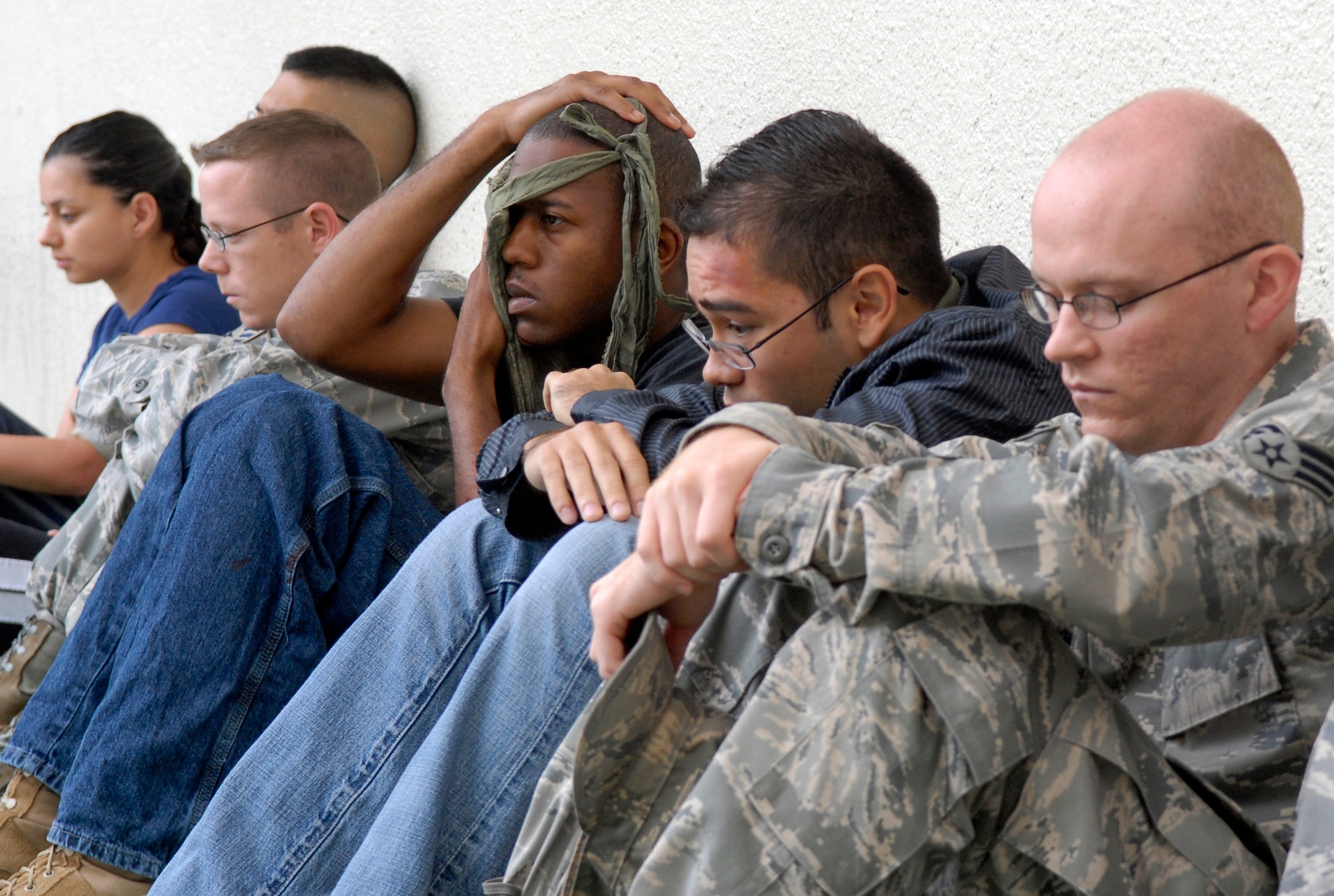 Simulated victims of an active shooter scenario wait for care to arrive after initial self-aid and buddy care during a Local Operations Readiness Exercise, May 17 at Kadena Air Base, Japan. Beverly High 11-04, the May LORE, is one way Airmen train for real-world scenarios like they might be presented with one day. (U.S. Air Force photo/ Airman 1st Class Tara A. Williamson)