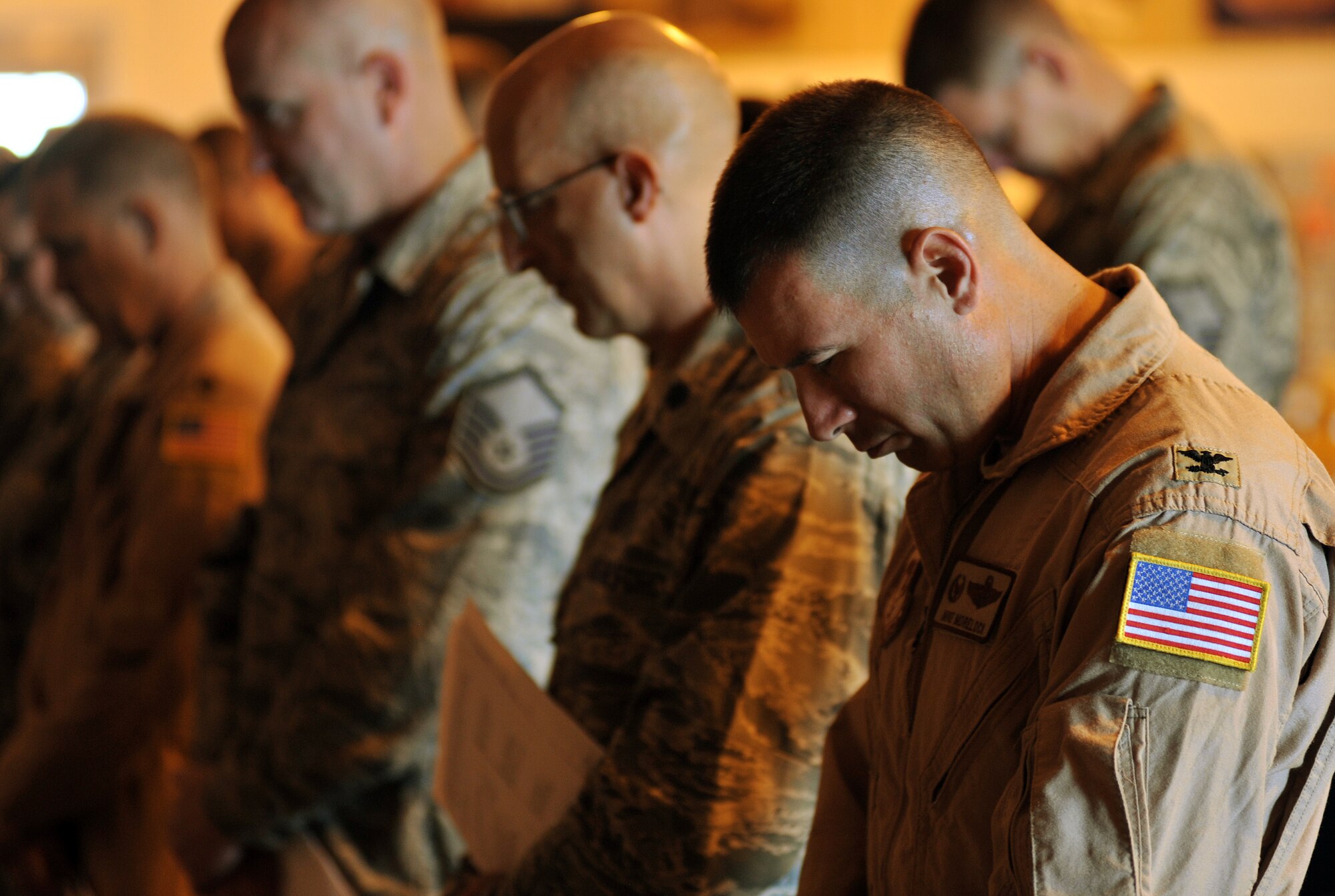 CAMP LEMONNIER, Djibouti – U.S. Air Force Col. Michael Morelock, 449th Air Expeditionary Group commander, pauses during opening prayer at a memorial service May 10 at the 11 Degrees North community center. The service was held to honor the eight airmen and one civilian killed at an Afghanistan airport April 27. (U.S. Air Force photo by Staff Sgt. R.J. Biermann)