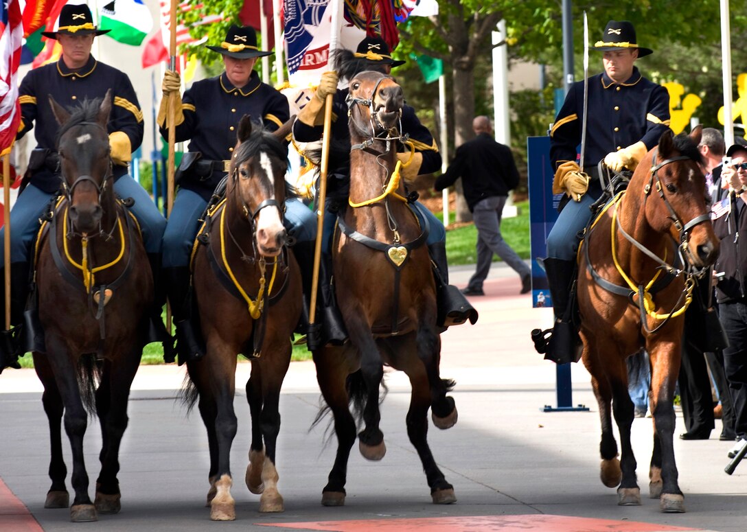 A horse rears as U.S. Army soldiers serving as members of the Fort Carson Mounted Color Guard ride down Olympic Path to a cheering crowd during the opening ceremony of the 2011 Warrior Games at the U.S. Olympic Training Center in Colorado Springs, Colo., May 16, 2011.