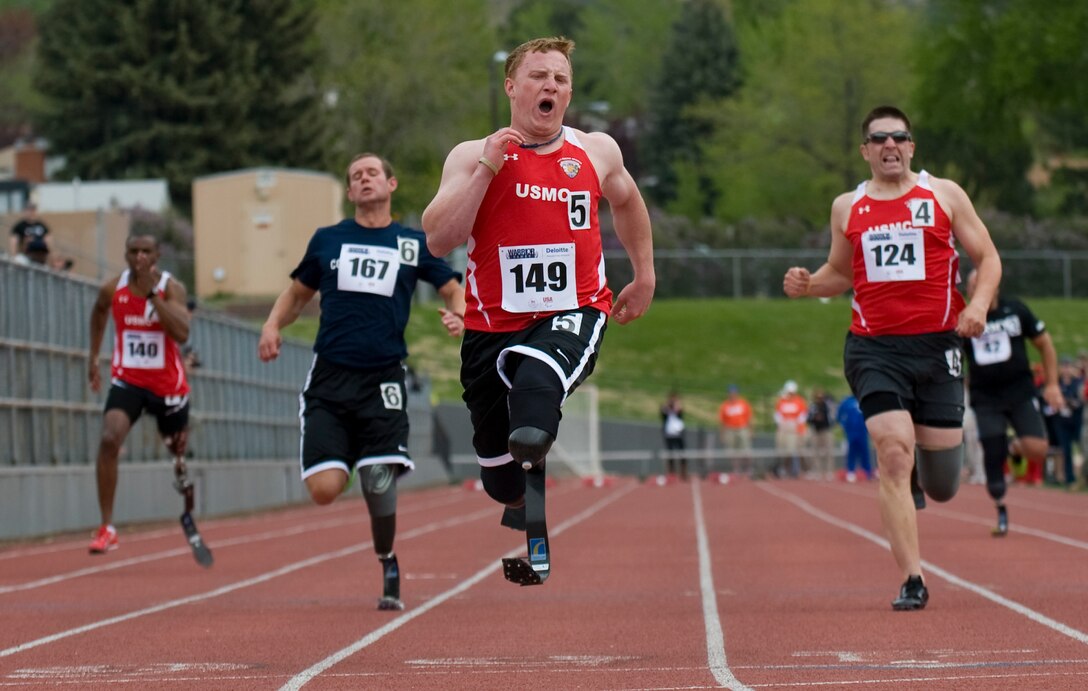 Athletes from military teams sprint across the finish line during the 100 Meter Dash at the 2011 Warrior Games in Colorado Springs, Colo., May 17, 2011. 