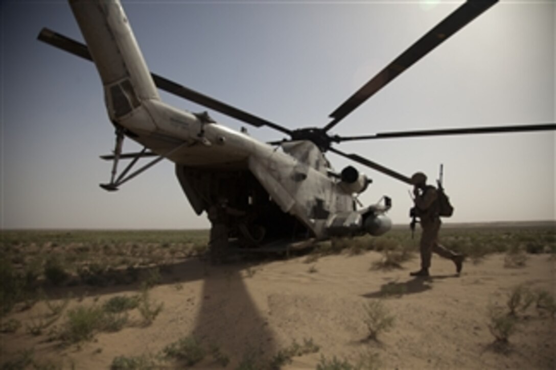 U.S. Marines with Bravo Company, 1st Battalion, 23rd Marine Regiment, Regimental Combat Team 1 board a CH-53D Sea Stallion helicopter assigned to Marine Heavy Helicopter Squadron 463 in Helmand province, Afghanistan, on May 9, 2011.  Both the Helicopter Squadron and Combat Team supported operation Aero Hunter to disrupt suspicious activity and counteract enemy drug and weapons trafficking in support of Operation Enduring Freedom.  