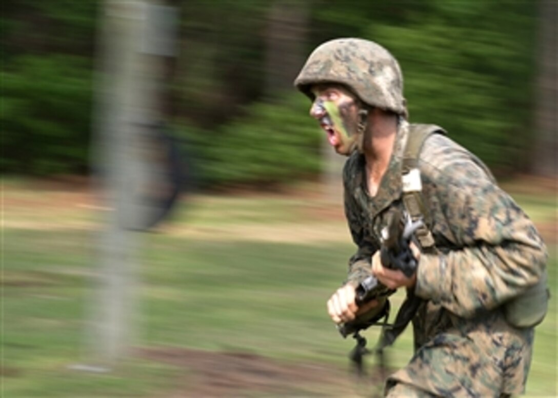 A Marine recruit charges the next obstacle while going through the bayonet assault training course at Parris Island, S.C., on May 13, 2011.  
